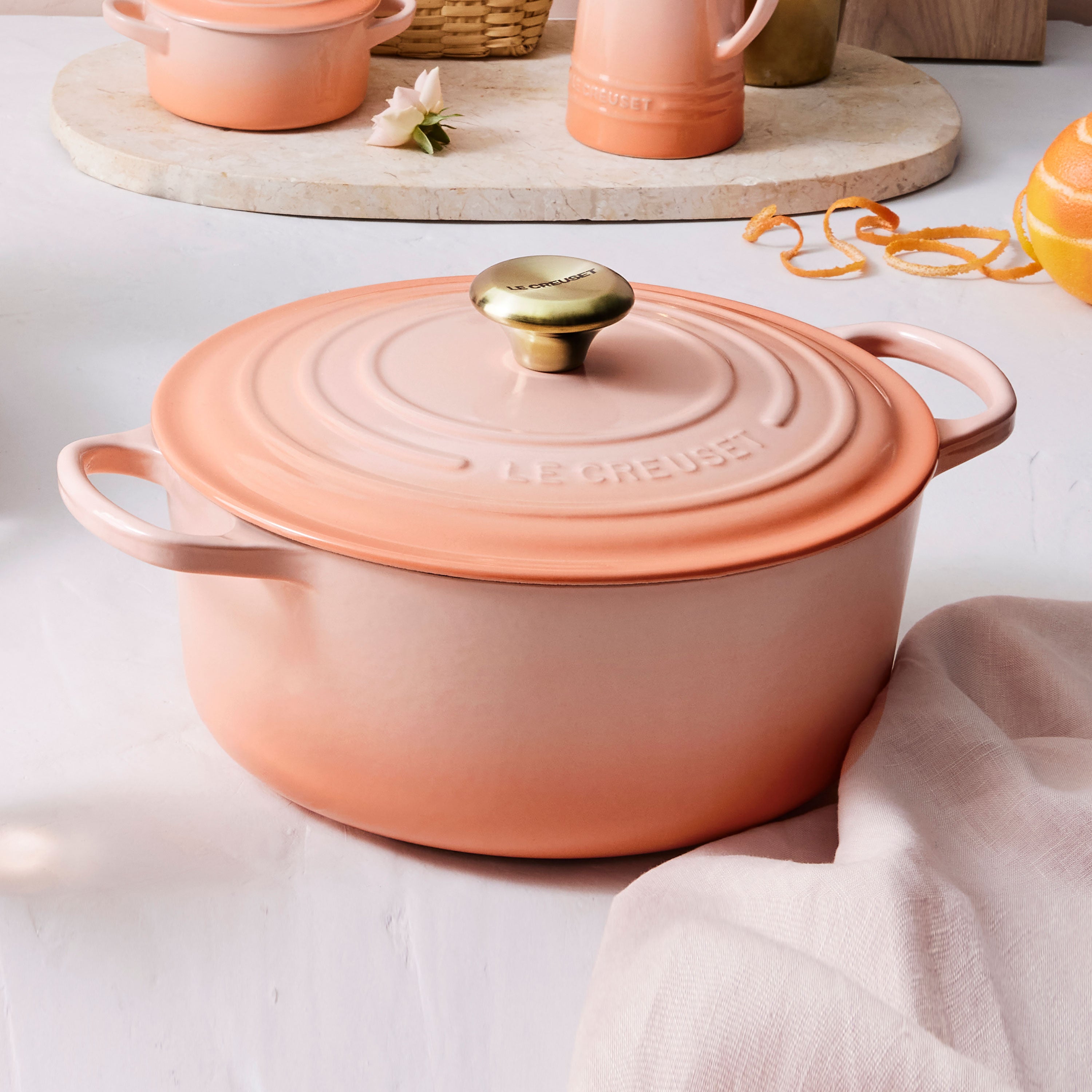 Close-up of the light gold stainless steel knob on the Le Creuset enameled Dutch oven, emphasizing its quality and heat resistance.