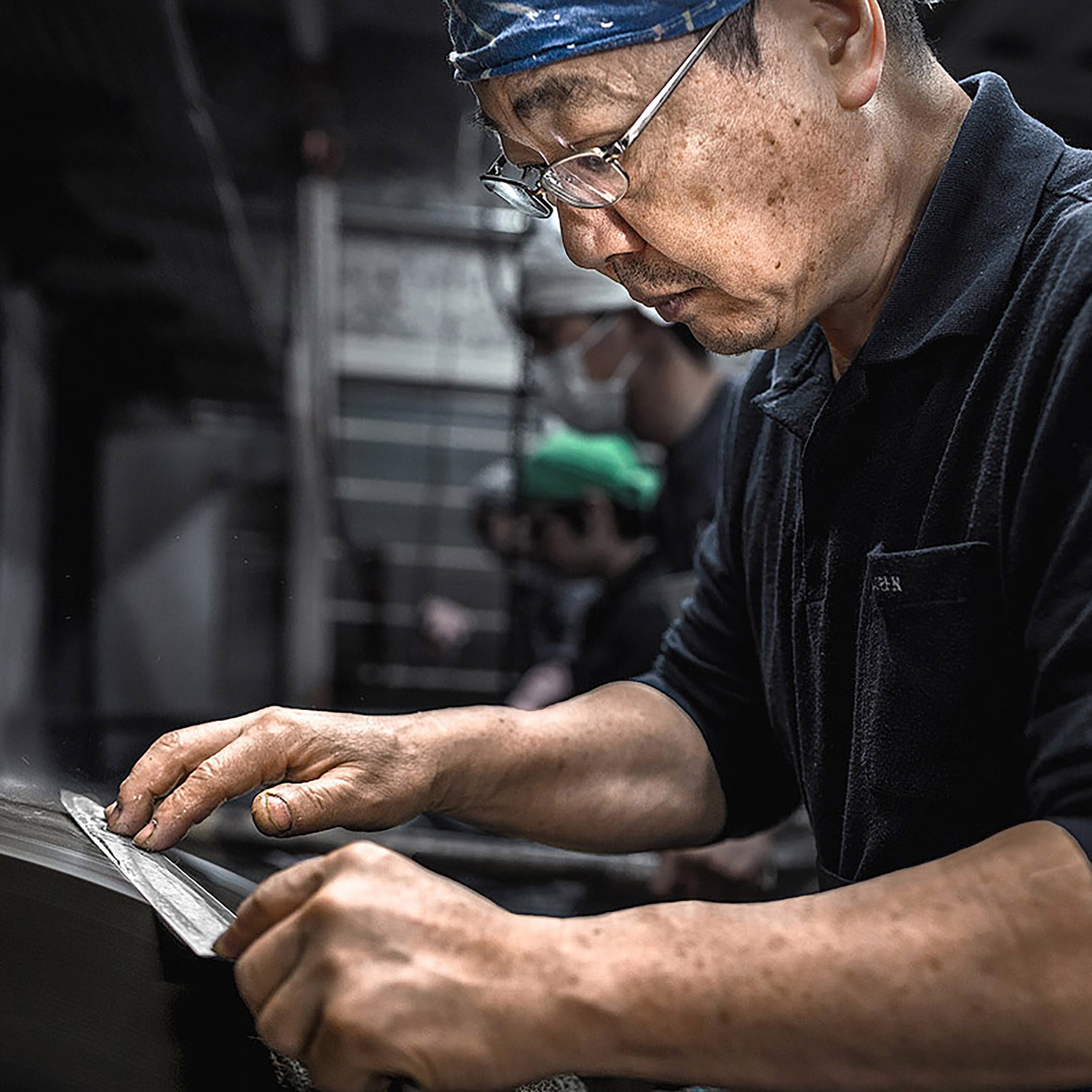 Chef slicing sashimi with the Takayuki Ginsan Sujihiki, ideal for clean cuts and presentation.