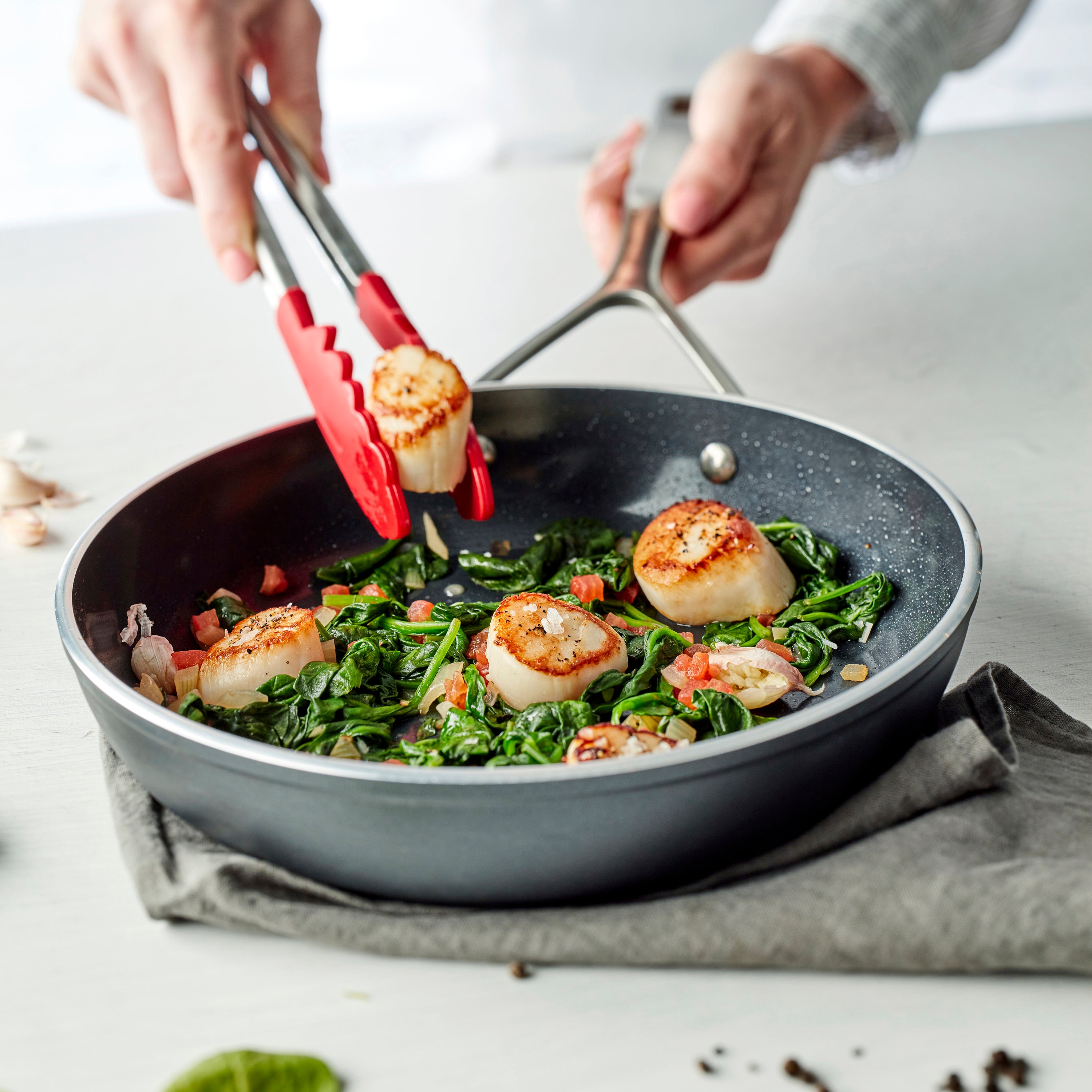 Oven-safe ceramic frying pan with stainless steel handles, perfect for versatile cooking