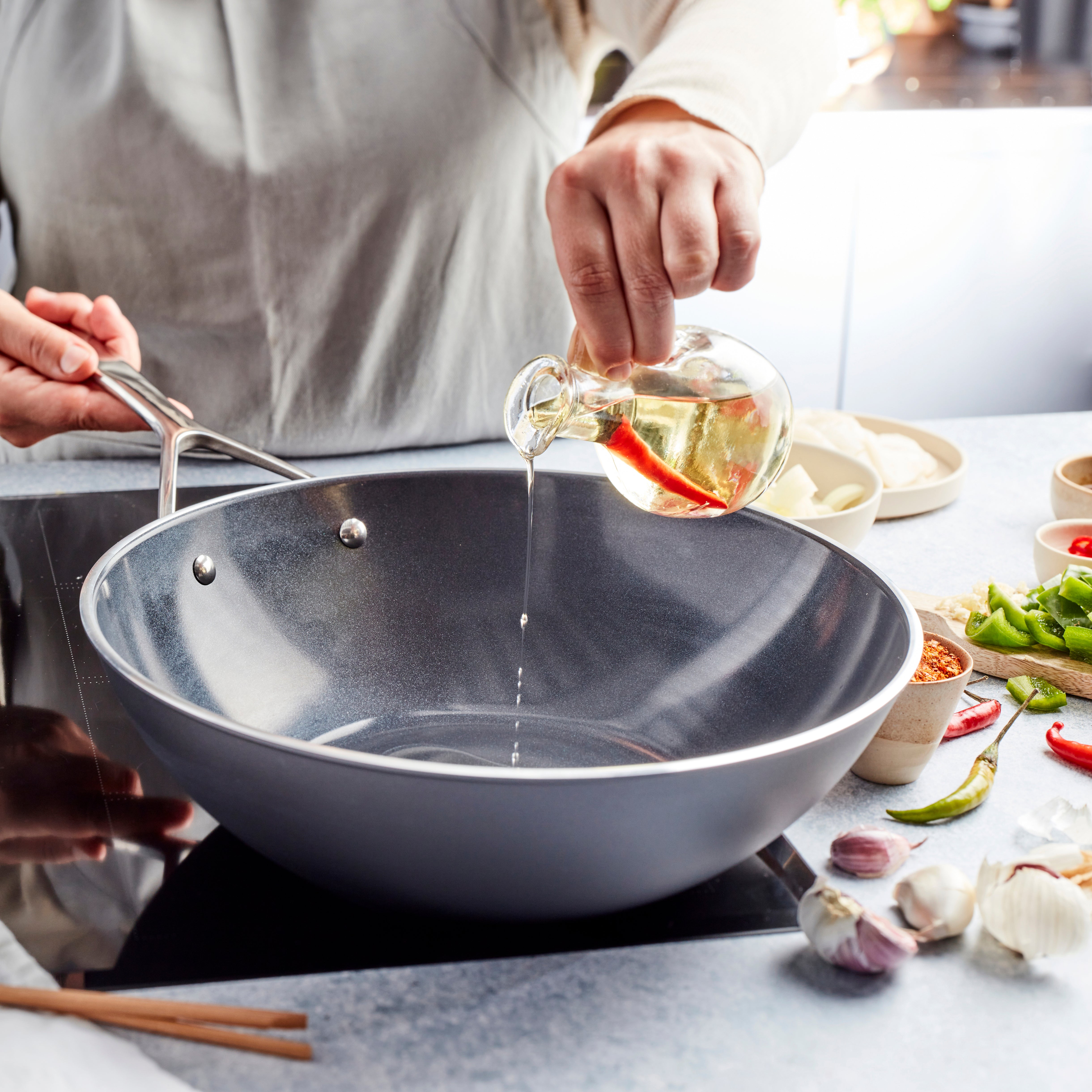 Overhead view of ceramic wok on induction cooktop, showcasing even heat distribution