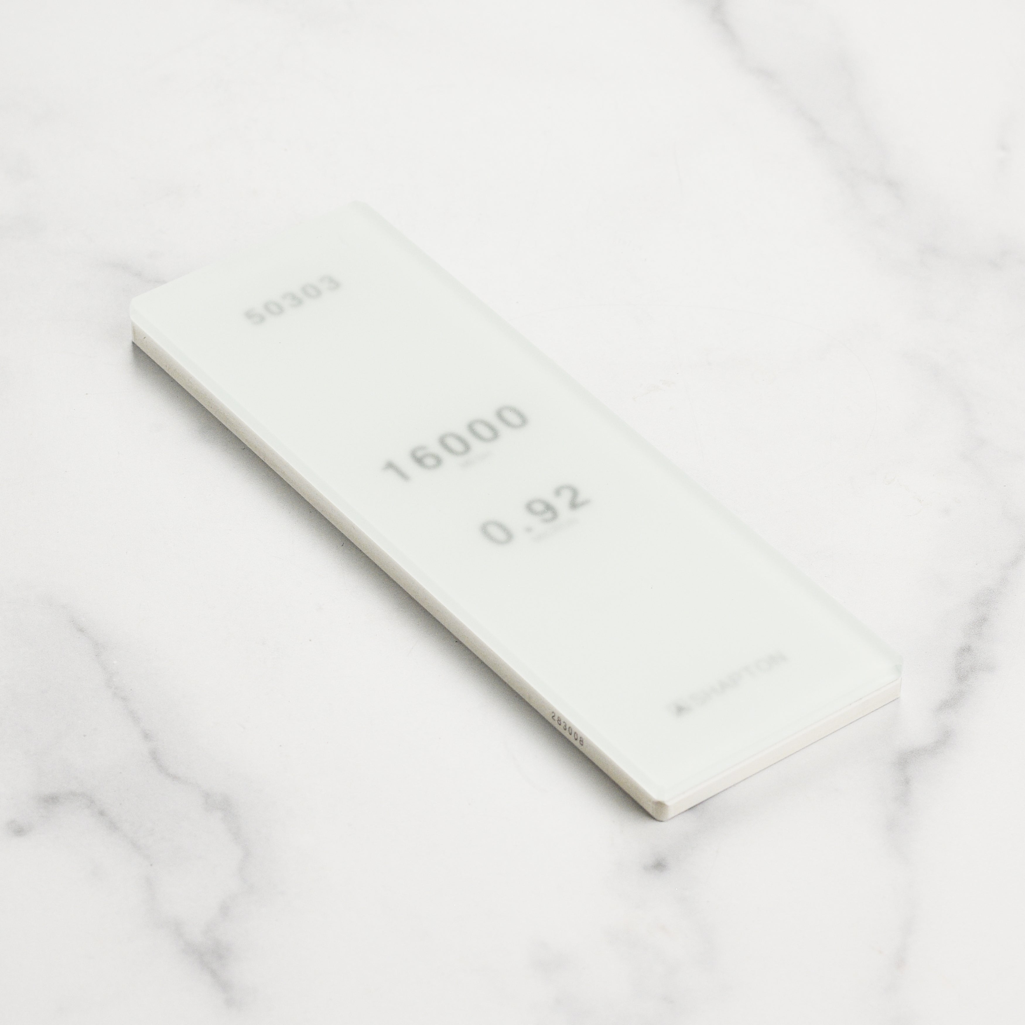 Close-up of the Shapton 16,000 grit stone with a knife on it.