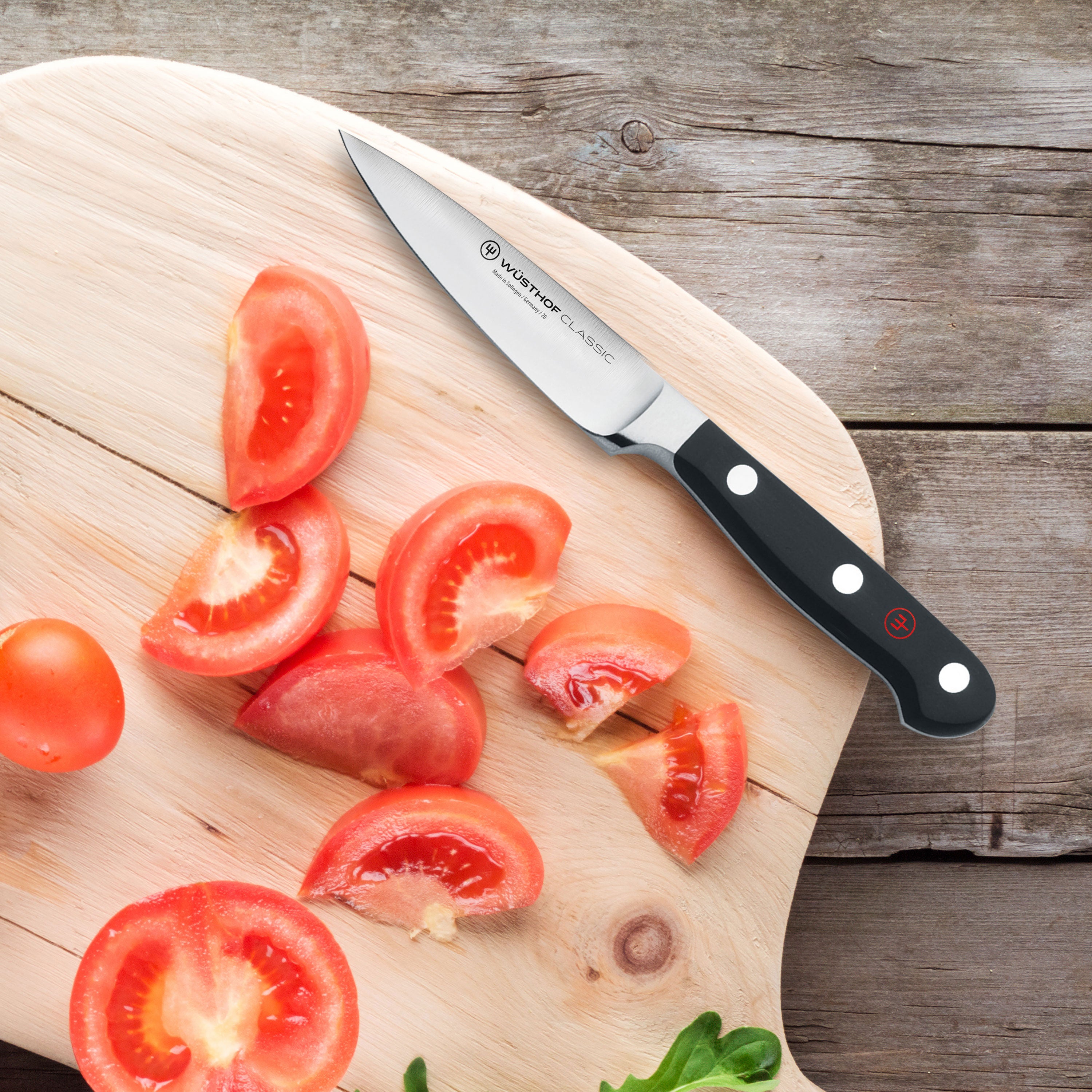Close-up of Wusthof chef knife with high carbon steel blade in a kitchen setting