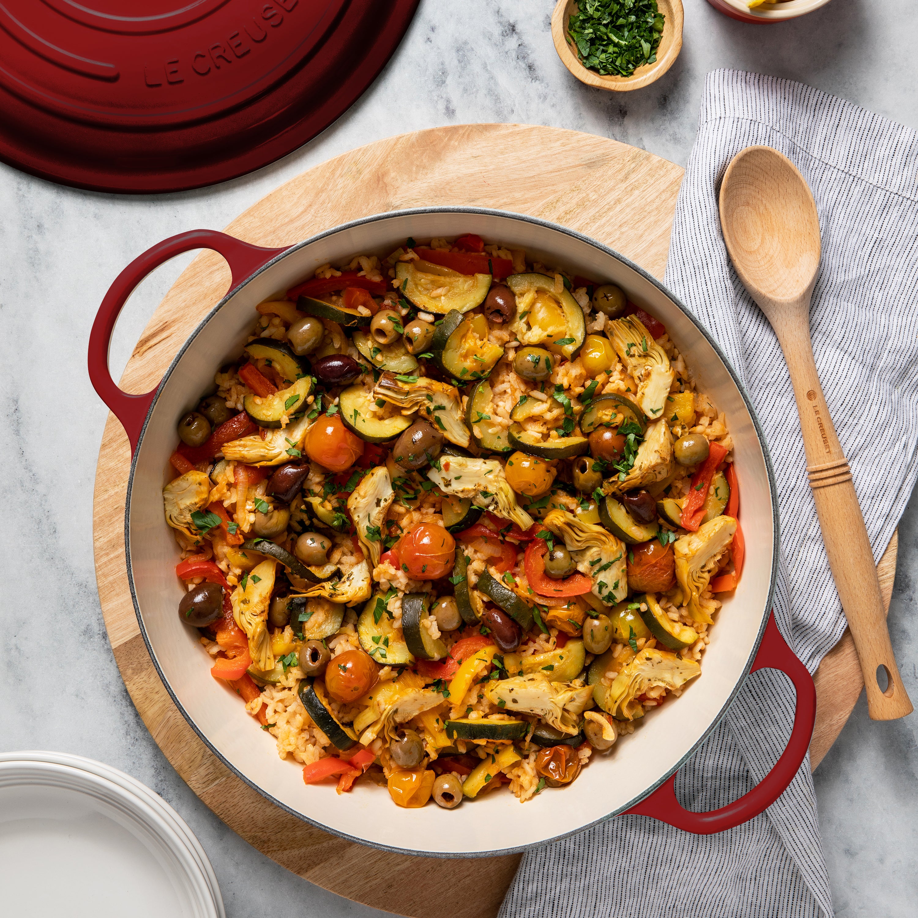 Close-up of the gold stainless steel knob on the Le Creuset cast iron oven, emphasizing its stylish and functional features.