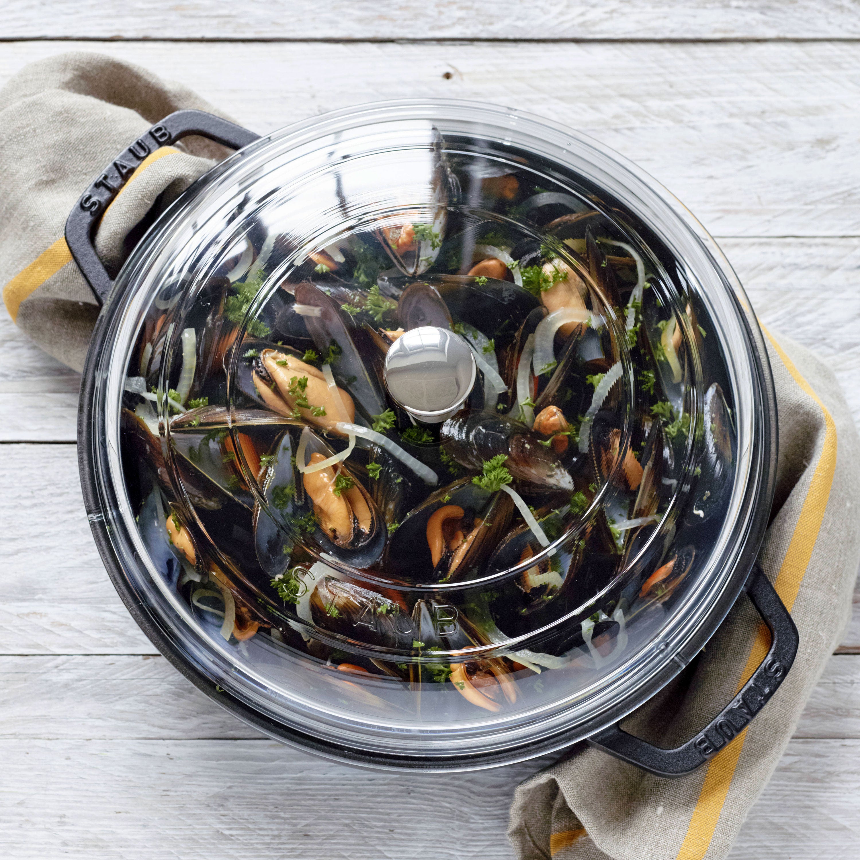 Elegant presentation of the Staub black braiser on a dining table, ready to serve.