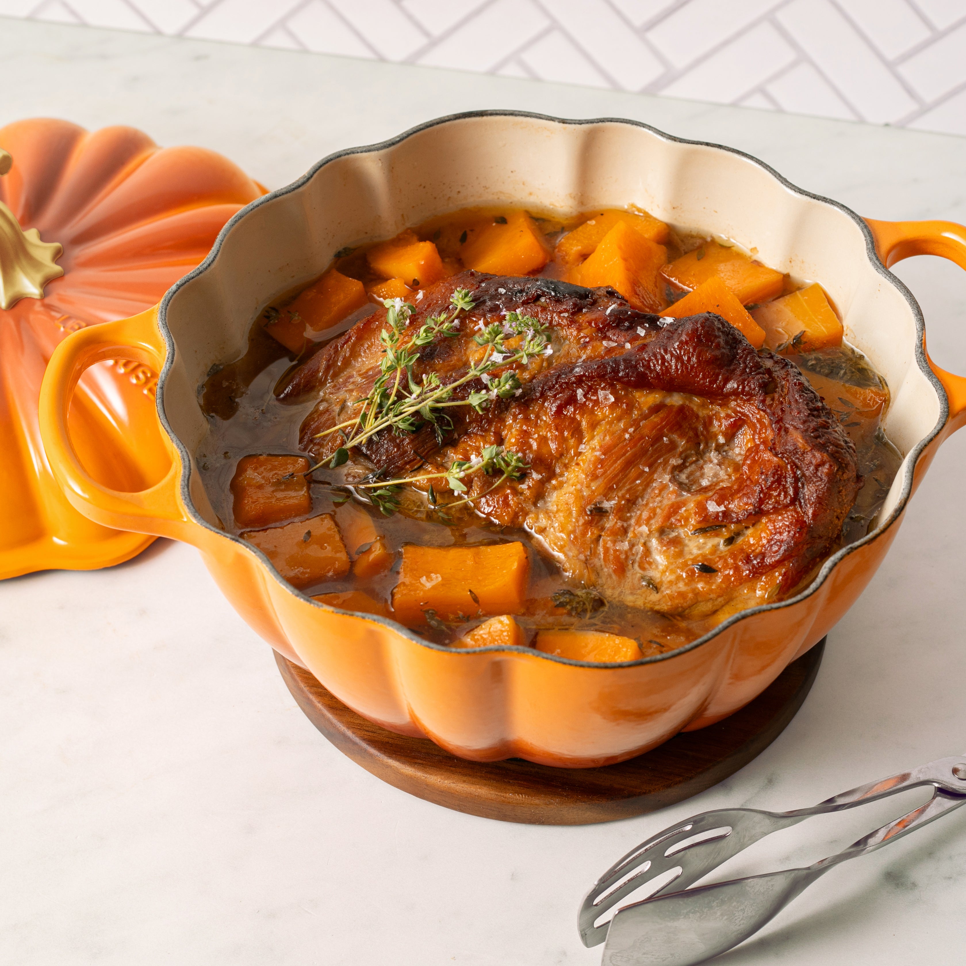 Le Creuset 4-quart cocotte in use on a stovetop, showcasing its compatibility with all cooktops.