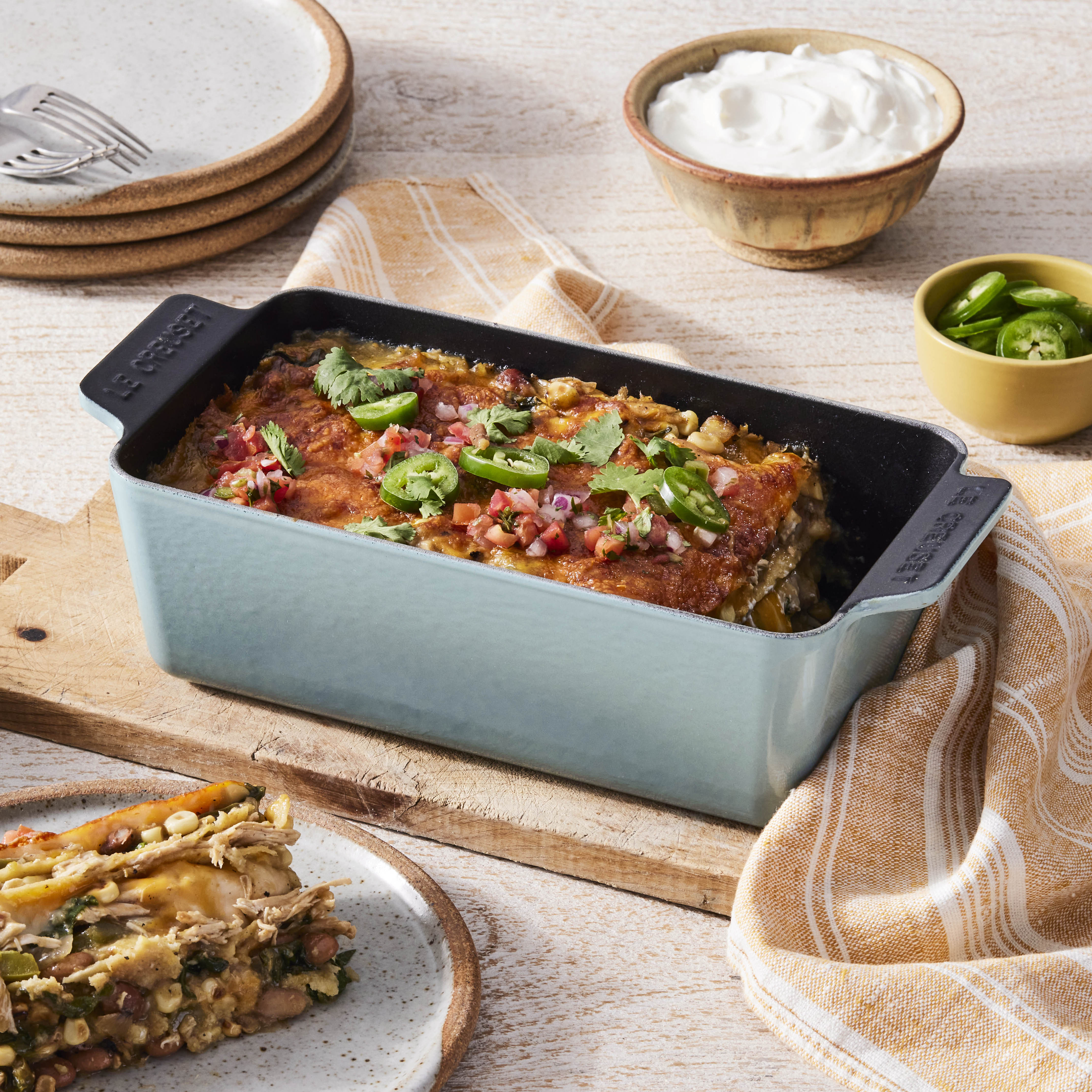 Side angle of the loaf pan with handles, highlighting its enameled cast iron body.