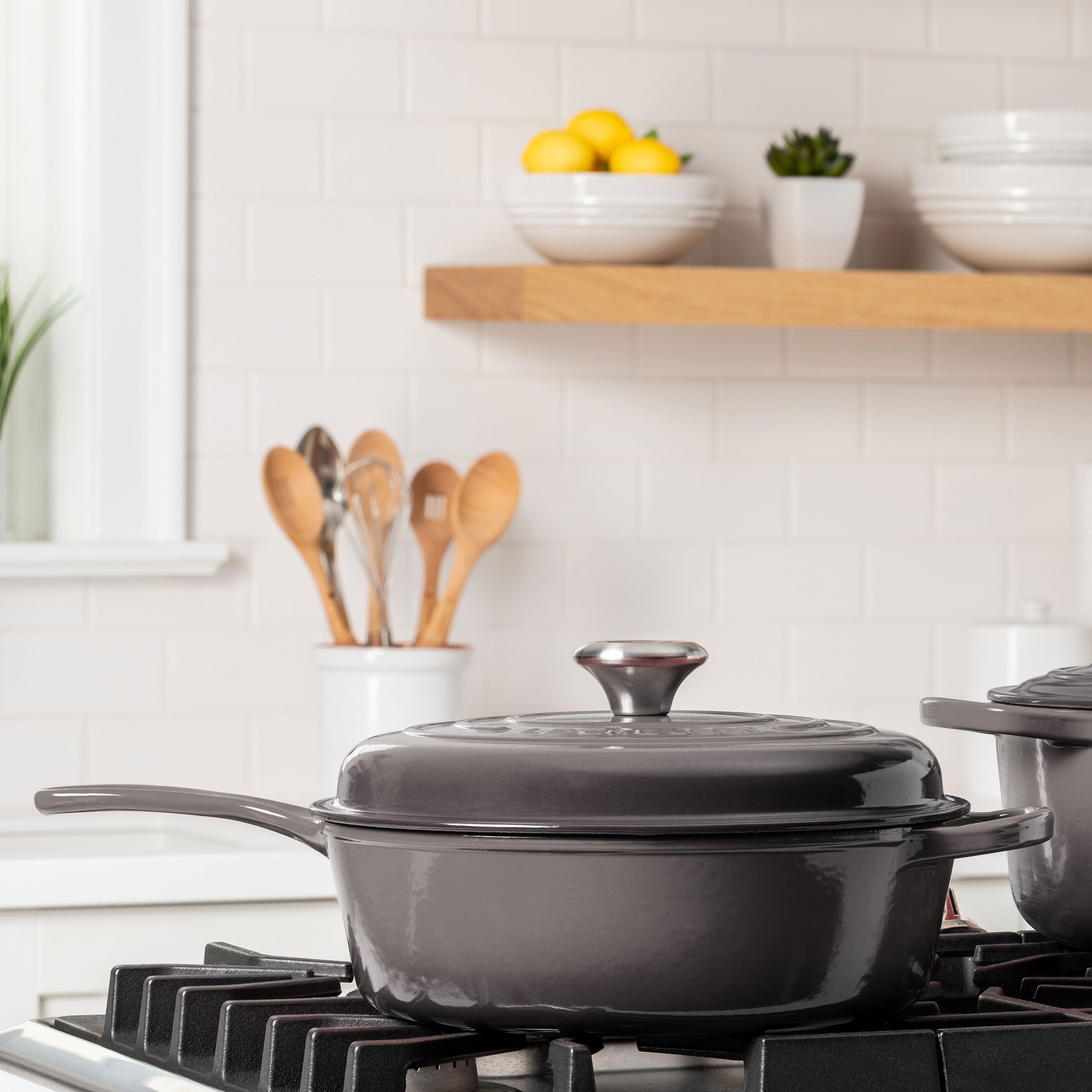 View of Le Creuset 3.75-quart Dutch oven in use on a stovetop, demonstrating its compatibility with all cooktops.