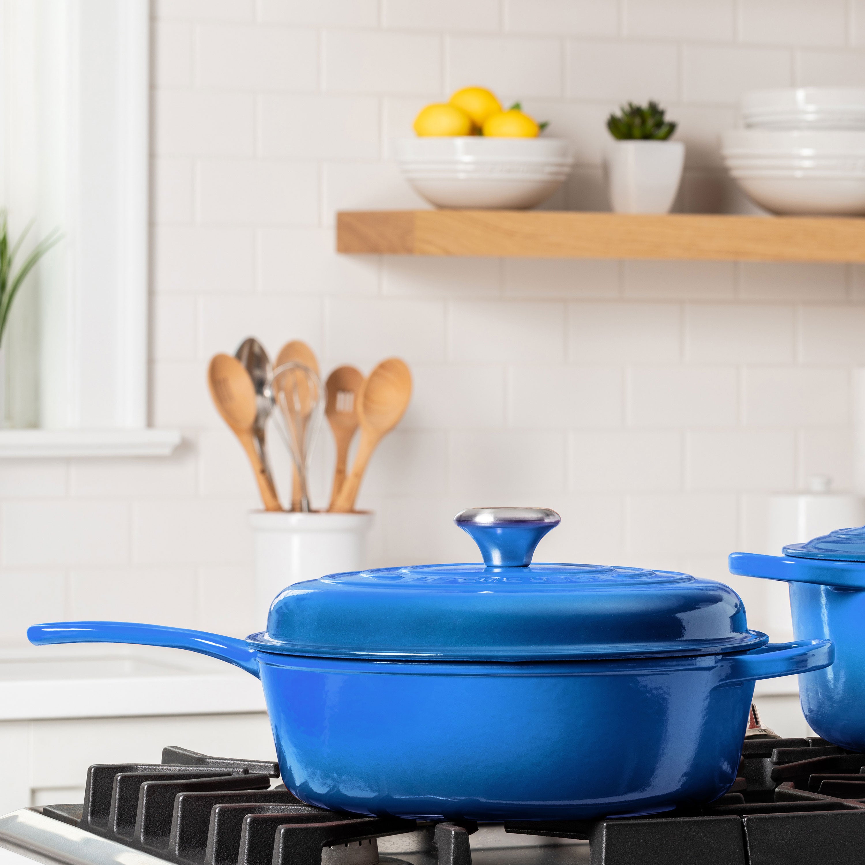 Le Creuset Marseille 3.75-quart cast iron pot on a stovetop, demonstrating its compatibility with various cooktops.