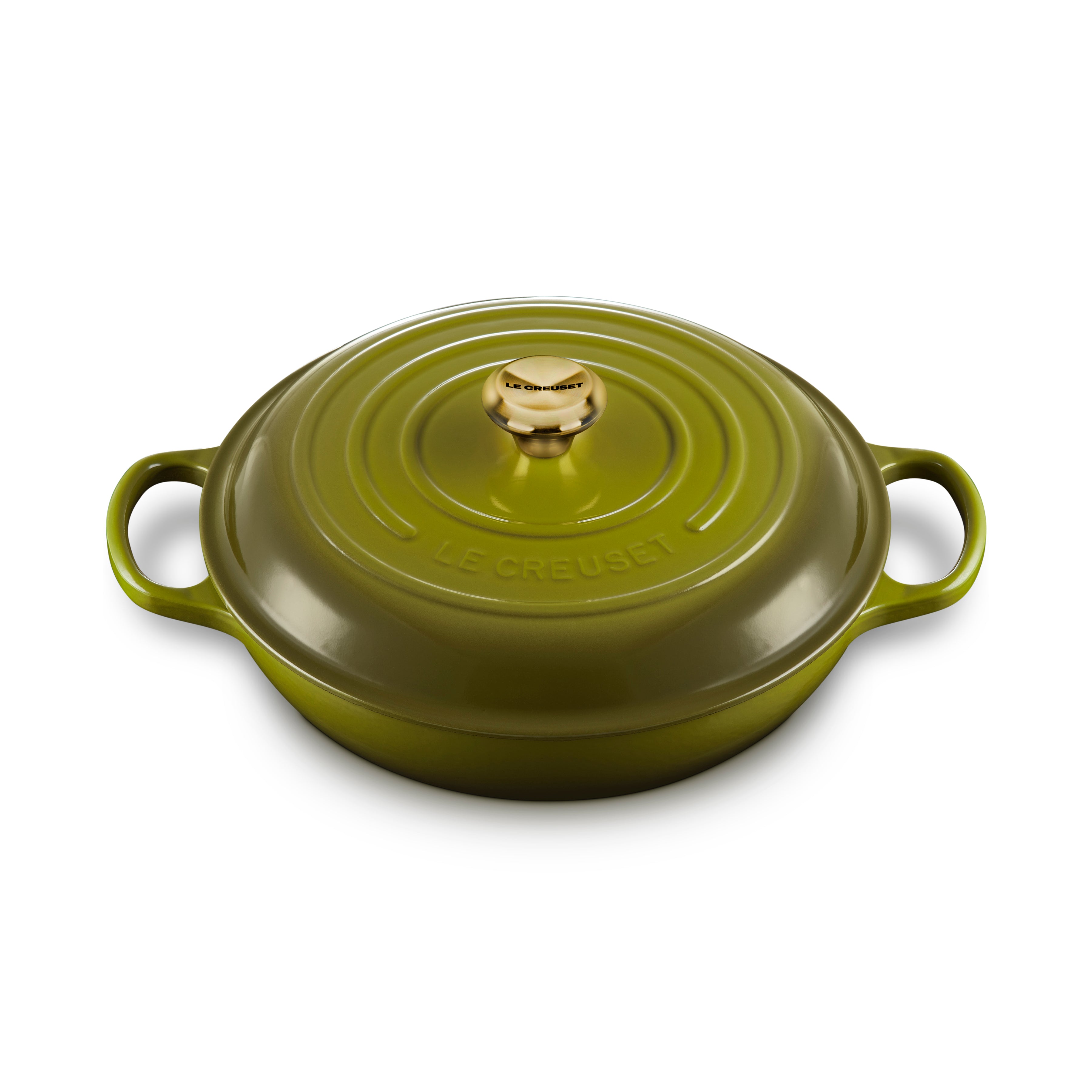Le Creuset signature cast iron braiser with lid on a stovetop, showcasing its durable enameled surface