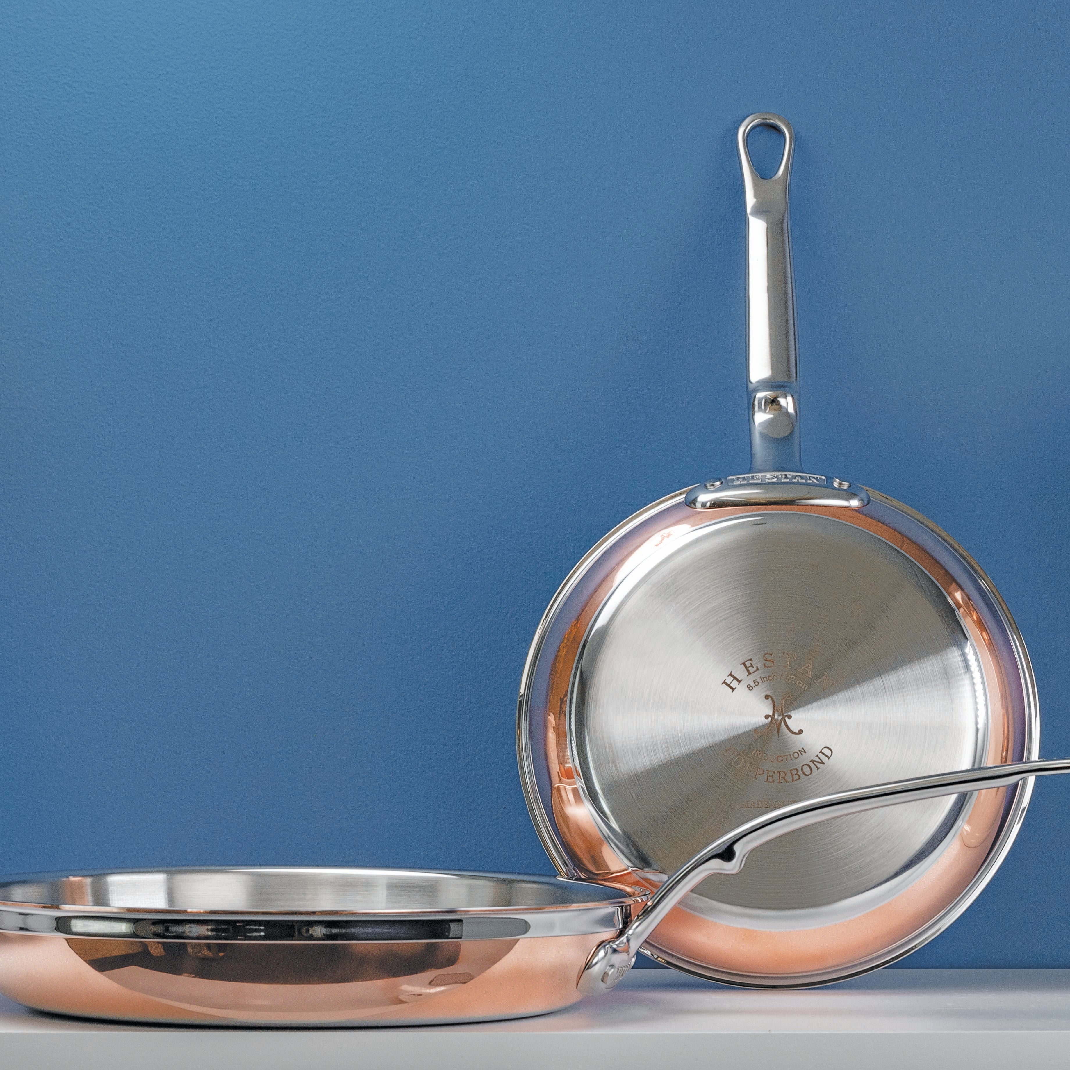 Hestan CopperBond pots and pans arranged on a kitchen counter, highlighting their elegant design and functionality.