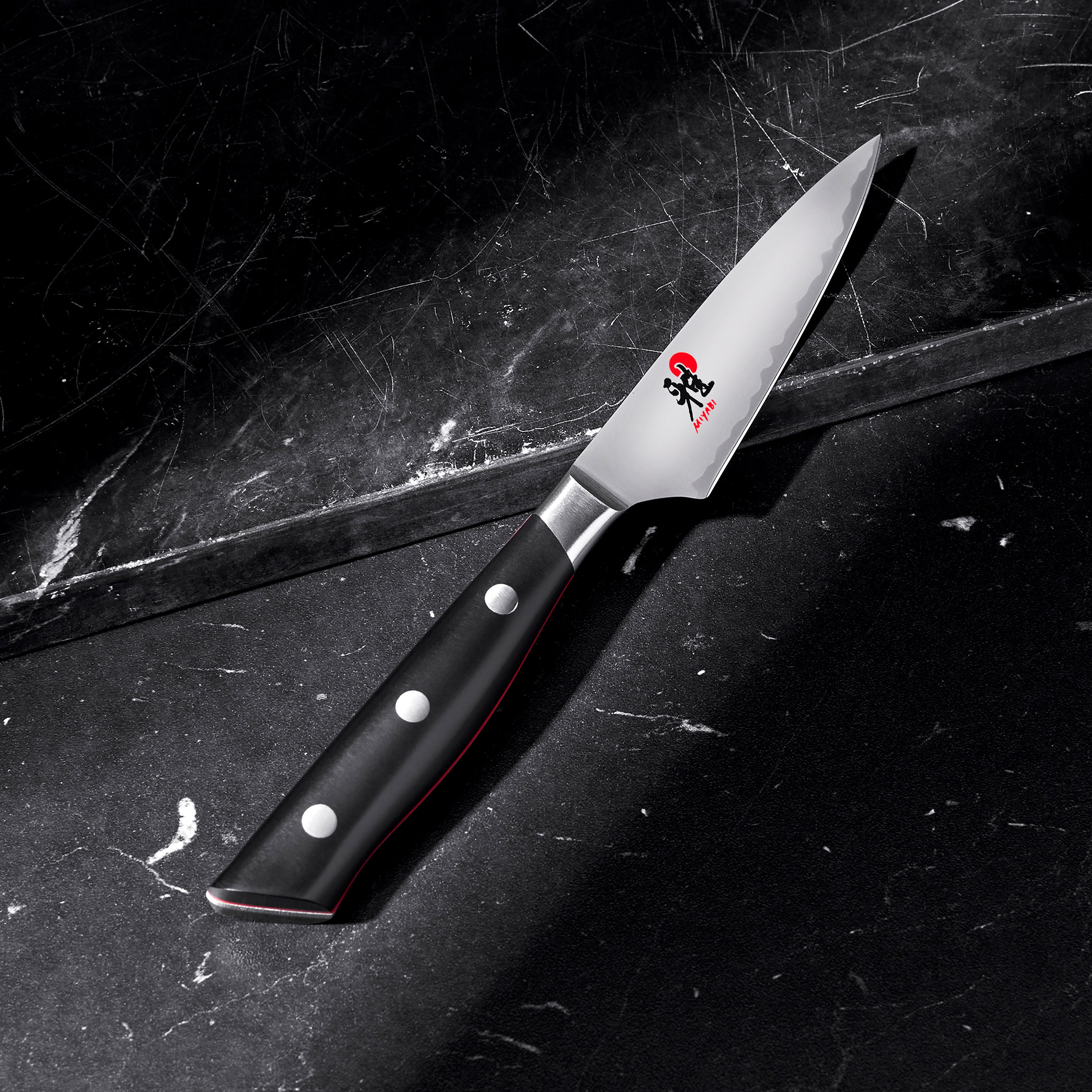 Miyabi Evolution paring knife displayed on a wooden cutting board, highlighting its craftsmanship and design.