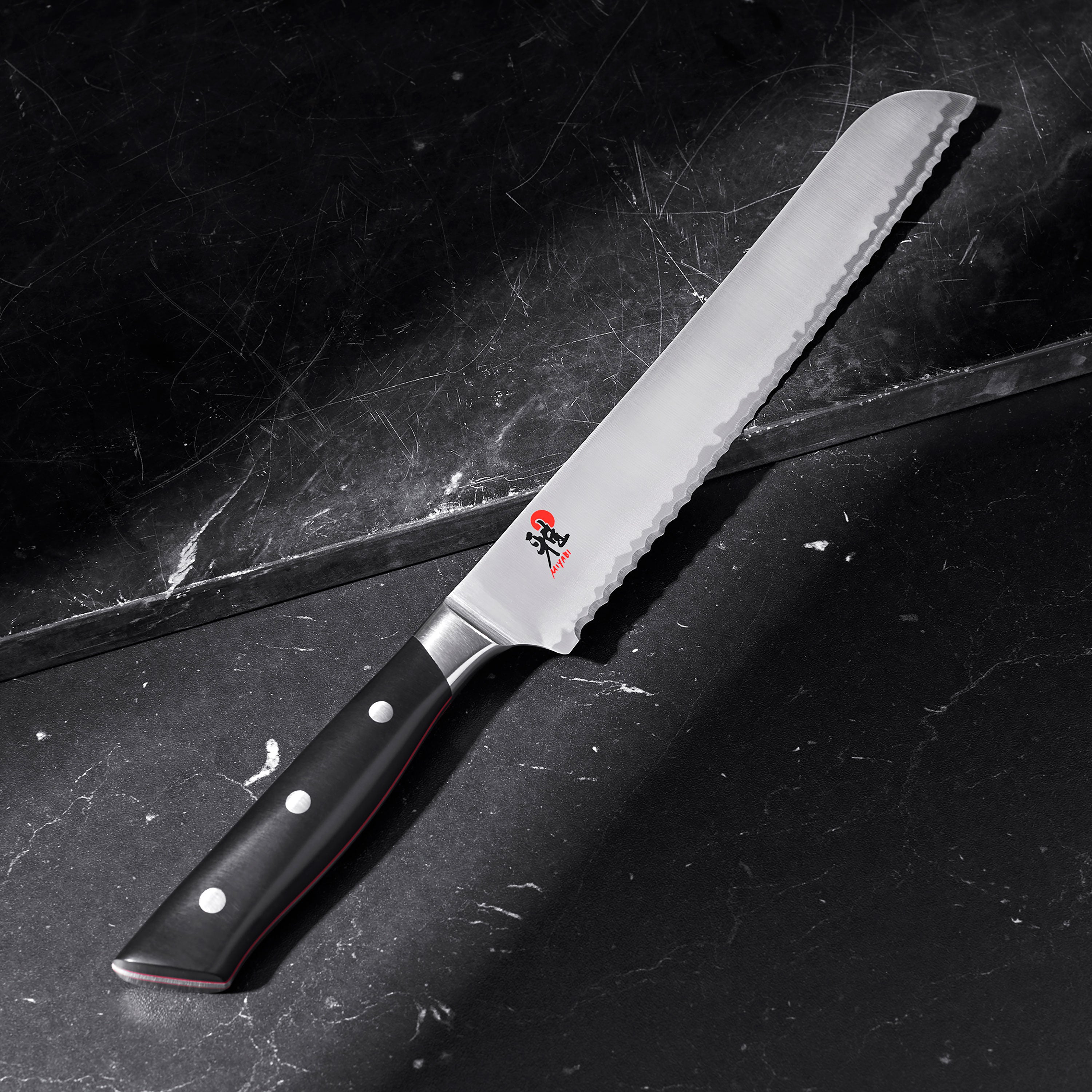 Miyabi Evolution chef knife set arranged in a stylish kitchen setting.
