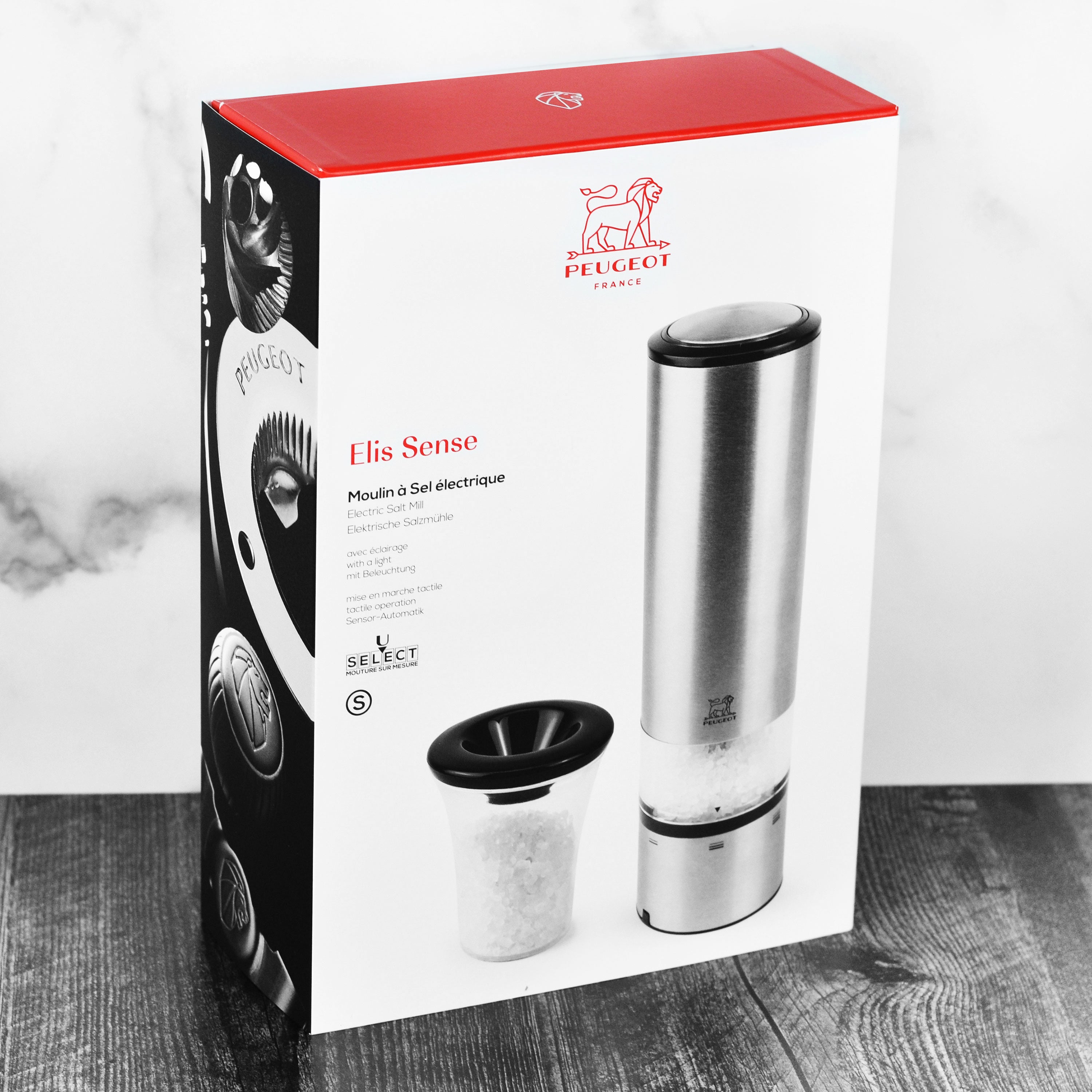Elegant stainless steel electric salt mill with LED light in use