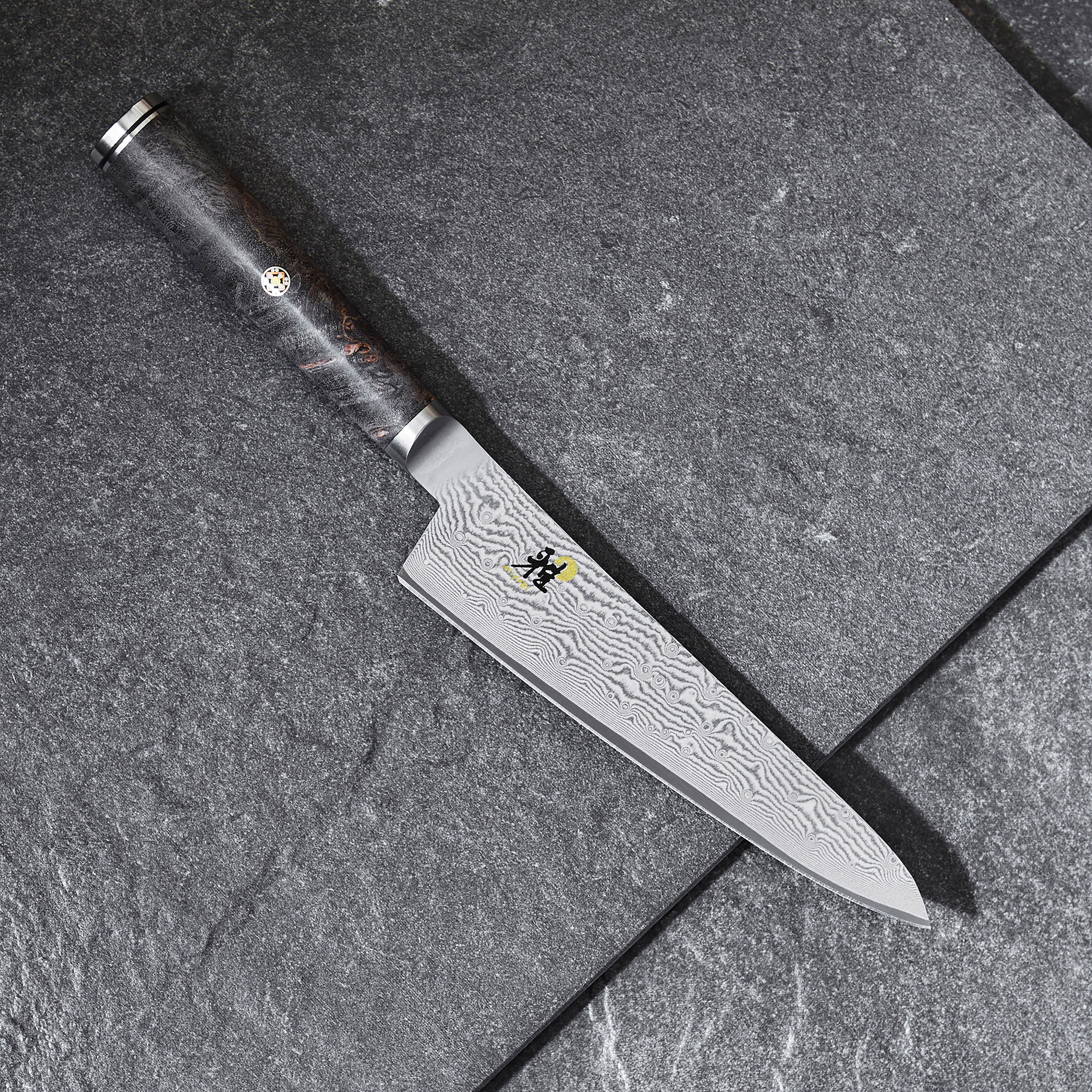 Japanese chef knife with black handle and mosaic pin for precision prep work