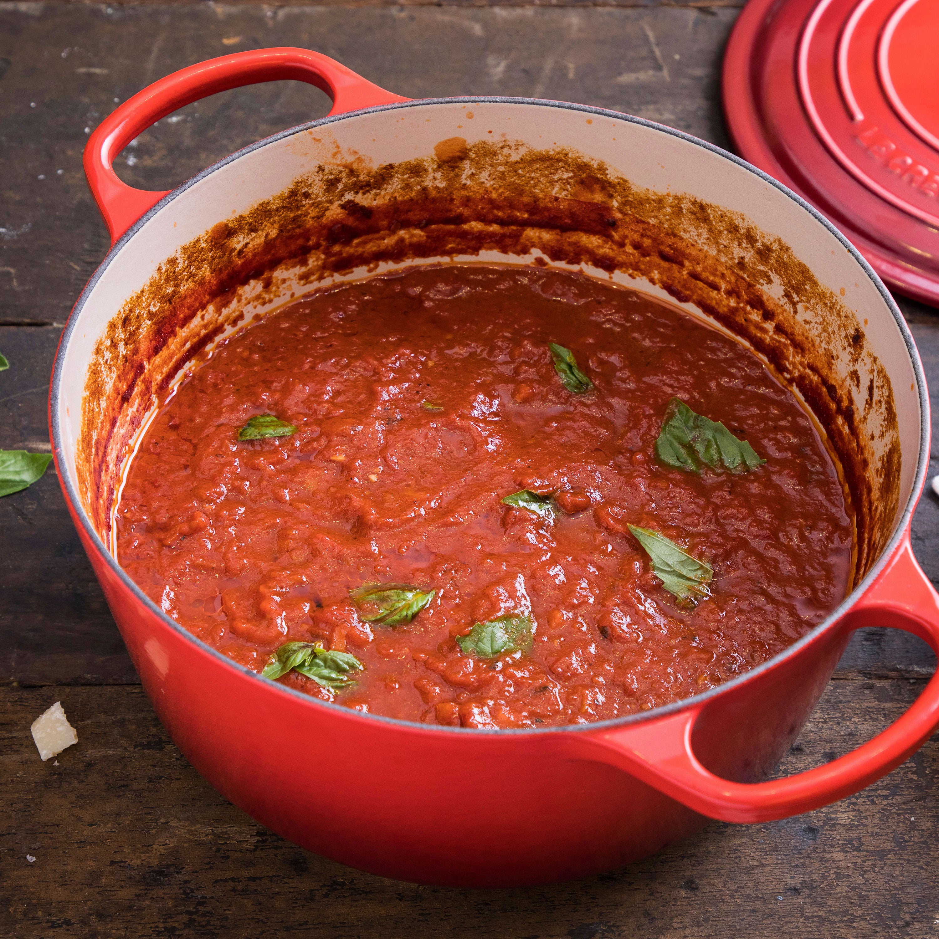 Le Creuset cast iron dutch oven showing its vibrant Cerise enamel finish and copper knob