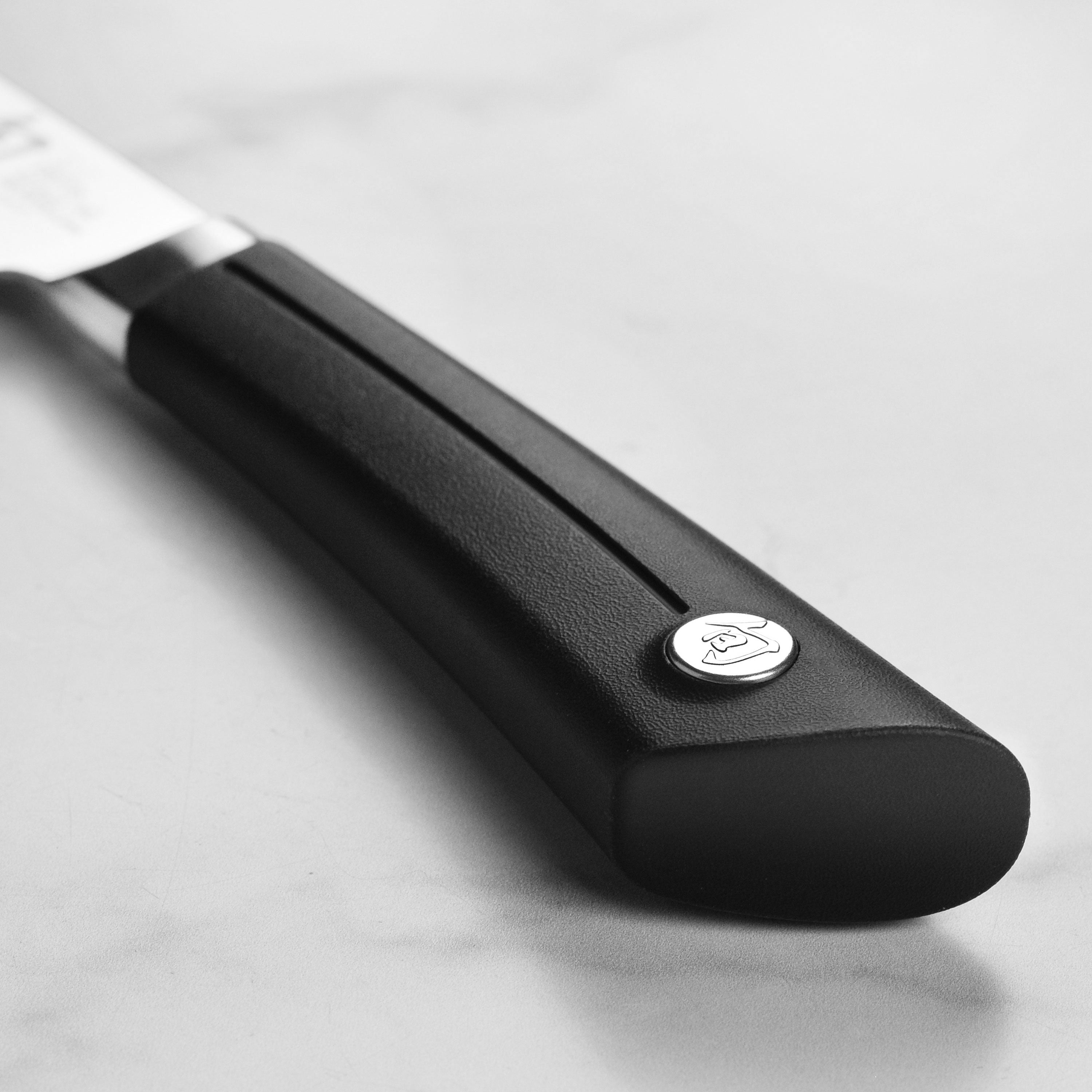 A side profile of the Shun Sora 6-inch Nakiri knife, highlighting the unique san mai edge and traditional Japanese craftsmanship.