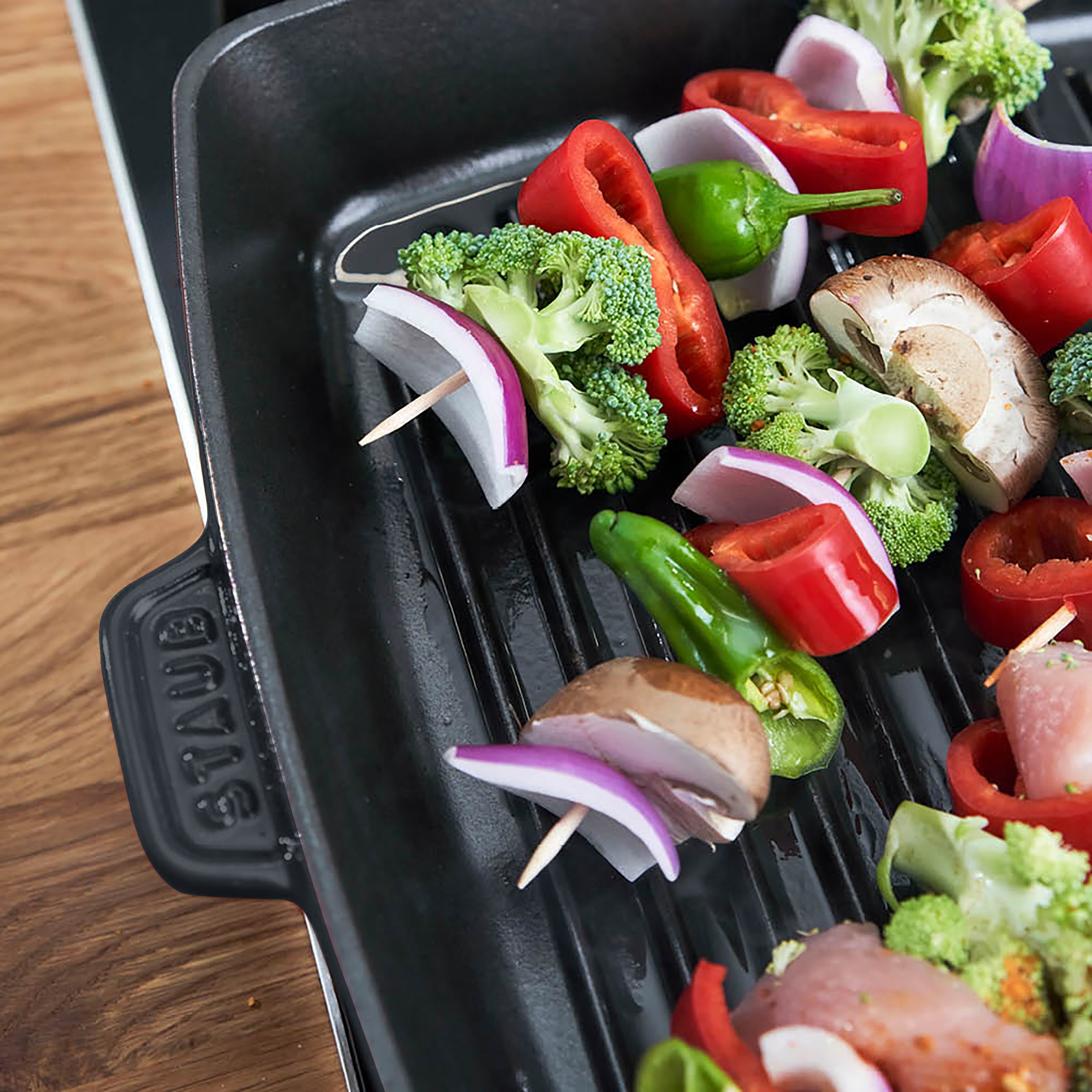 Enameled cast iron grill pan on induction cooktop showing heat distribution