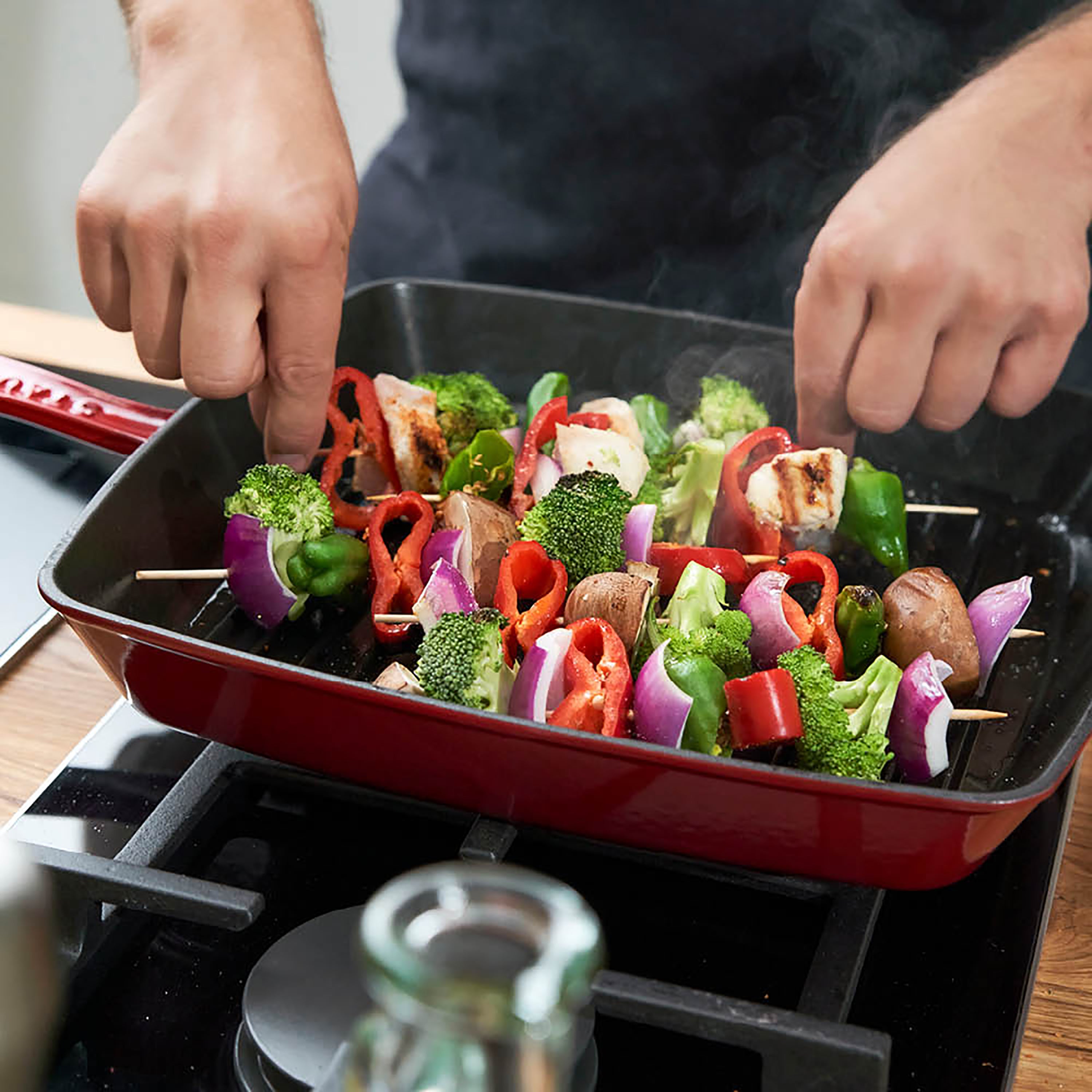 The Staub grill pan in action, grilling vegetables with perfect marks and even heat distribution.