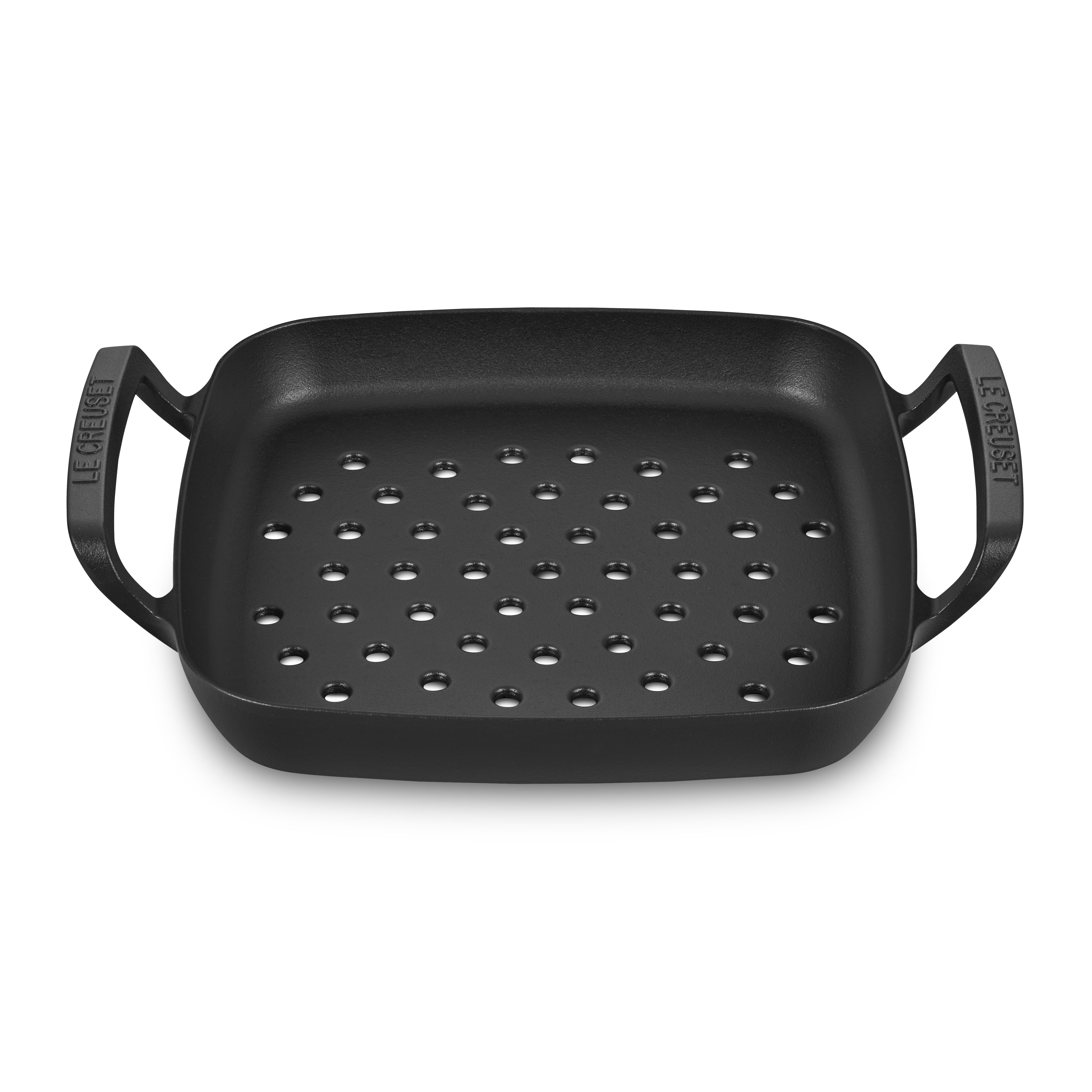 Le Creuset 12-inch cast iron grill basket with food on grill