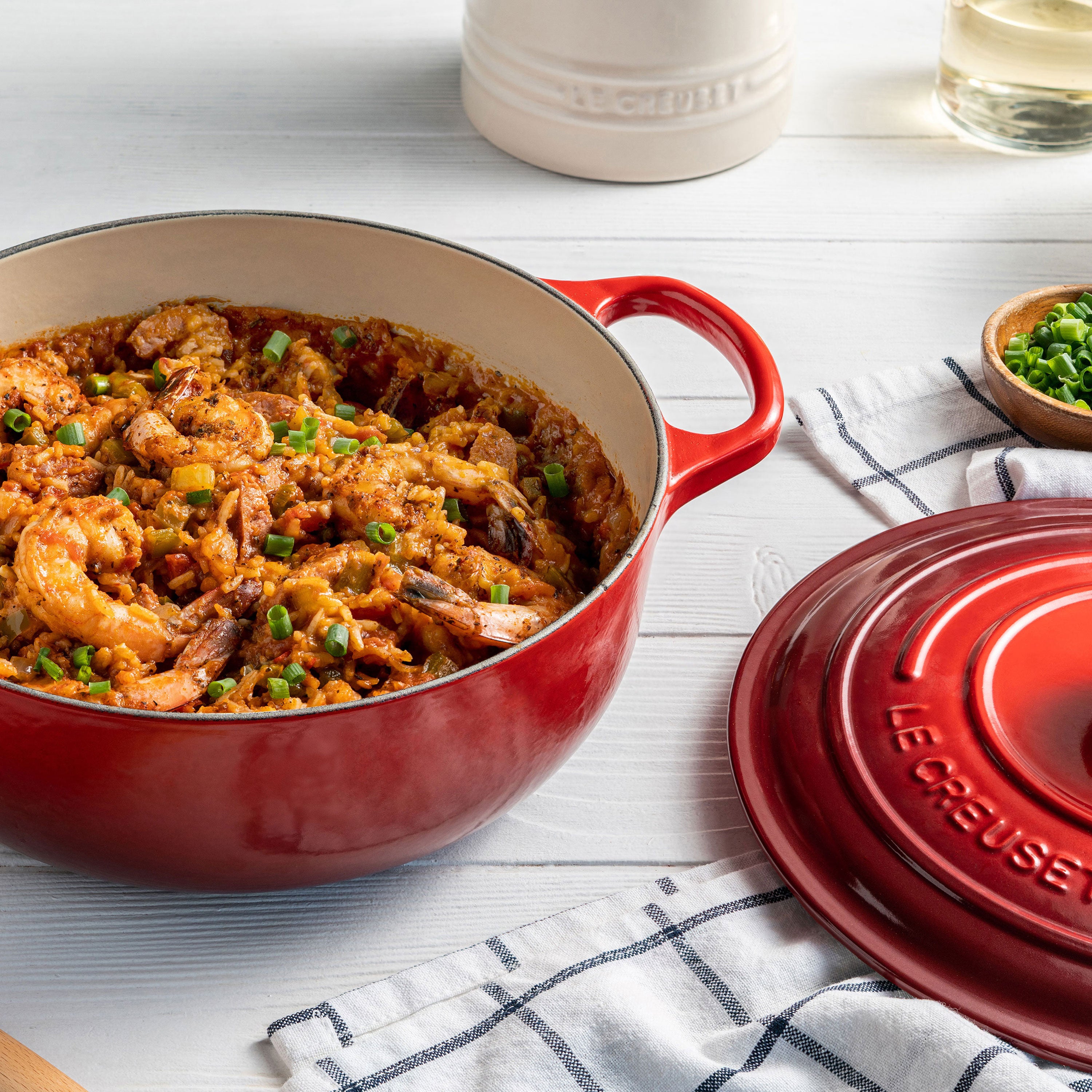 Close-up of enameled cast iron Dutch oven showing stainless knob and ergonomic handles