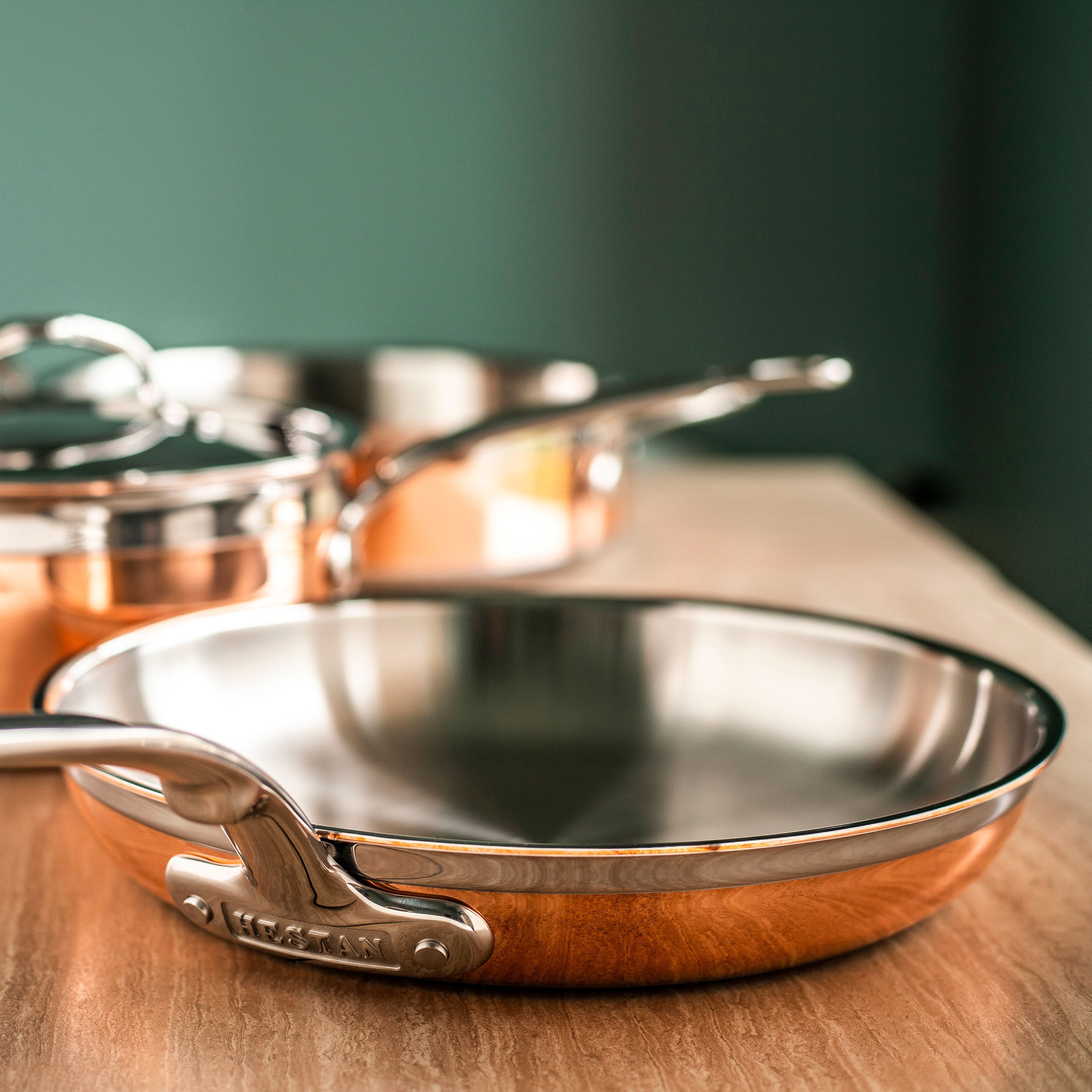 Hestan CopperBond pots and pans arranged on a kitchen counter, highlighting their elegant design and functionality.