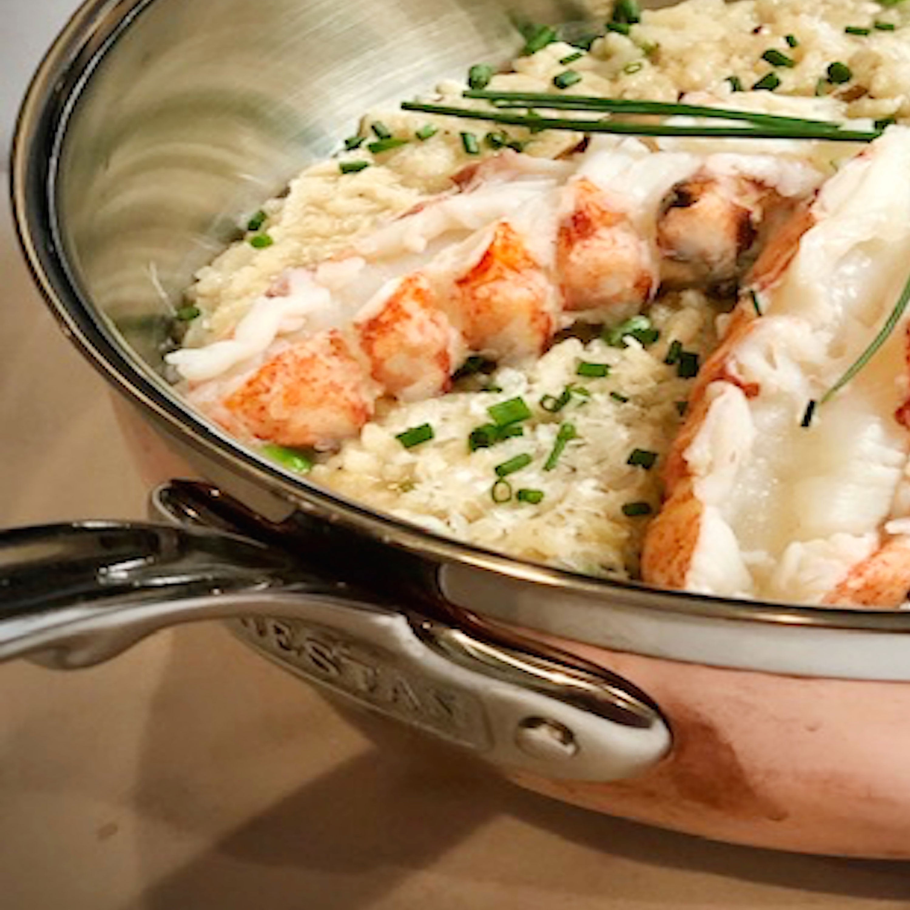 Hestan CopperBond cookware set showcasing the copper and stainless steel finish from an overhead angle.