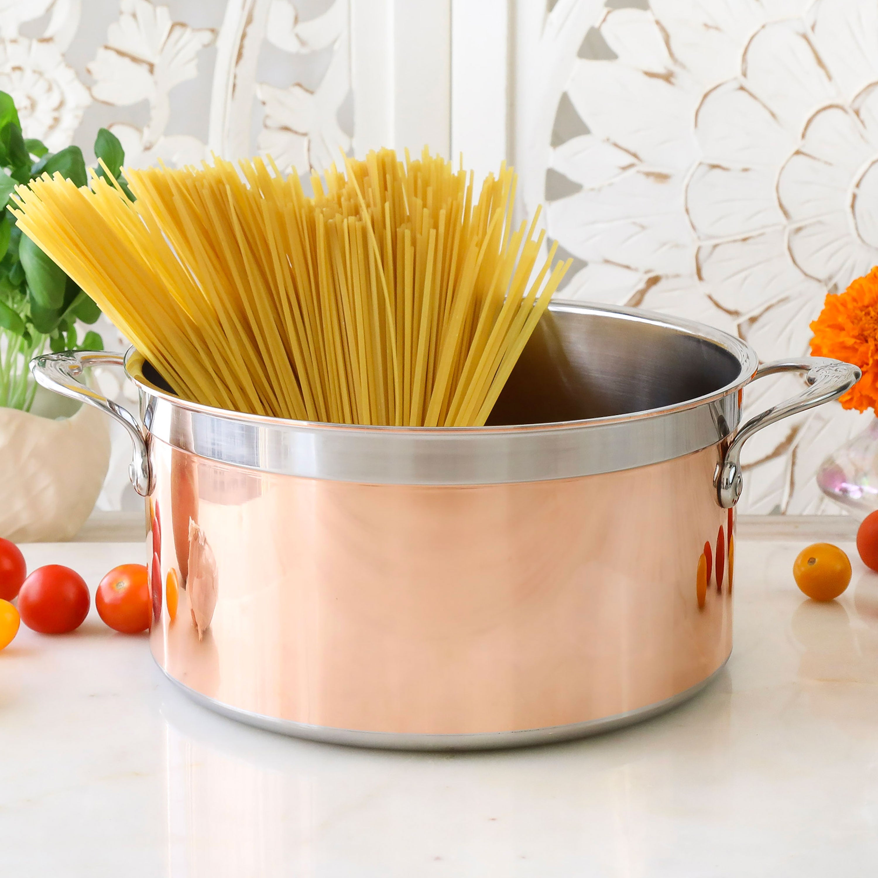 Hestan CopperBond pots and pans arranged on a kitchen counter, highlighting their elegant design and functionality.