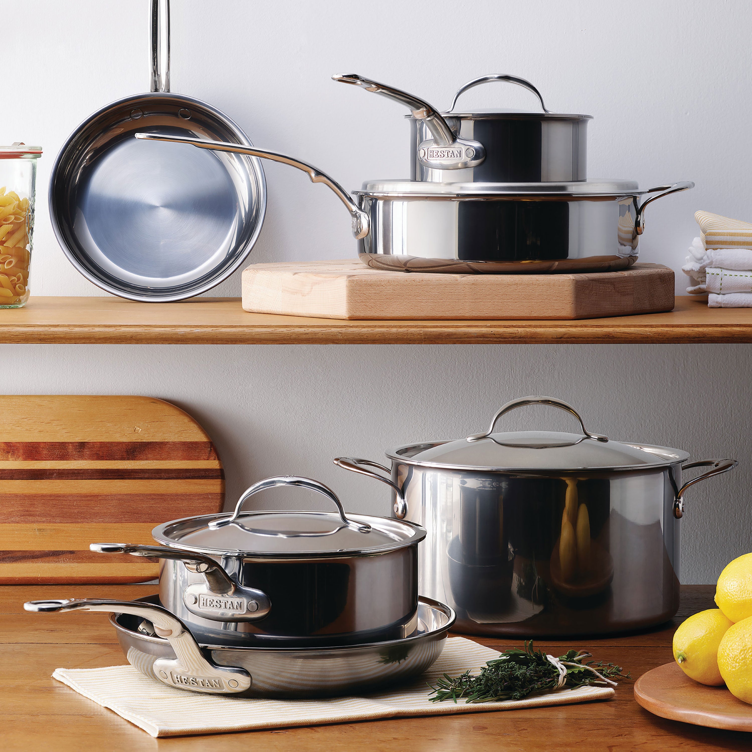 Hestan NanoBond 17 piece titanium stainless steel cookware set on stovetop showing sleek design