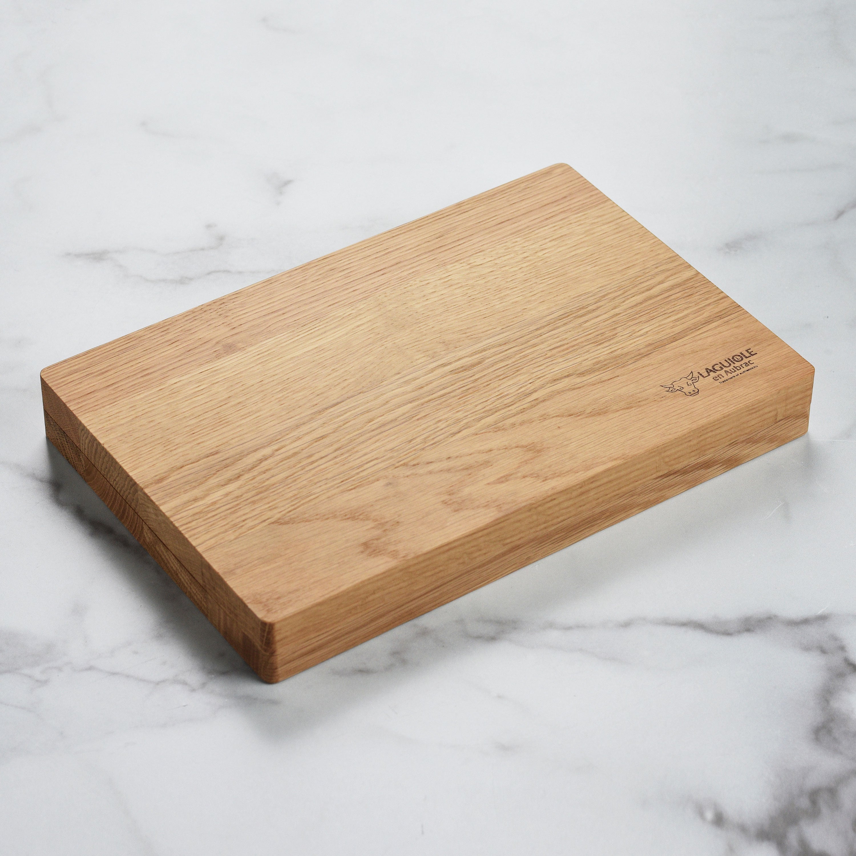Laguiole en Aubrac steak knives set with birchwood handles on a dining table.