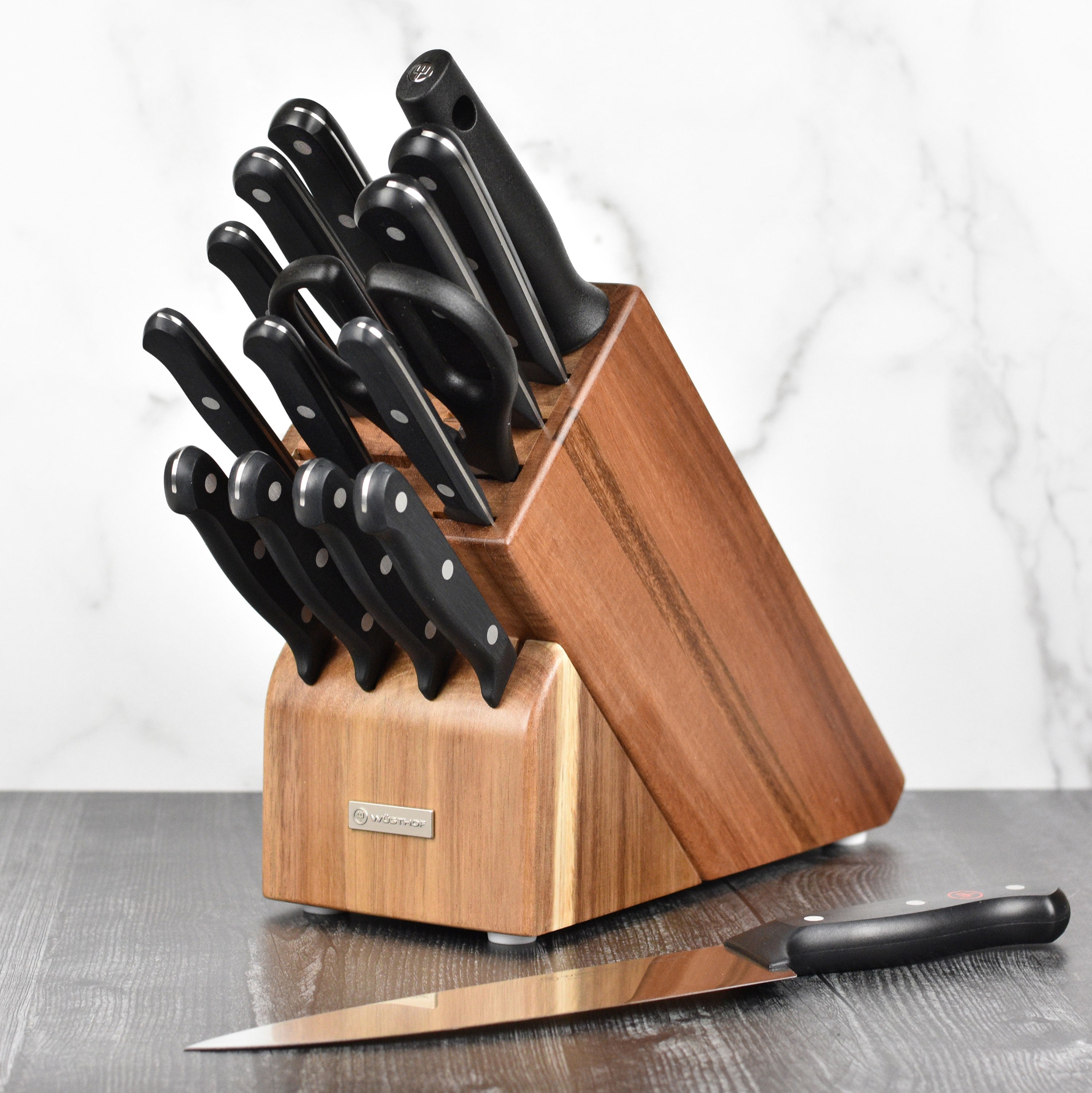 Wusthof Gourmet knife set displayed on a wooden cutting board, highlighting the sharp blades and ergonomic design.