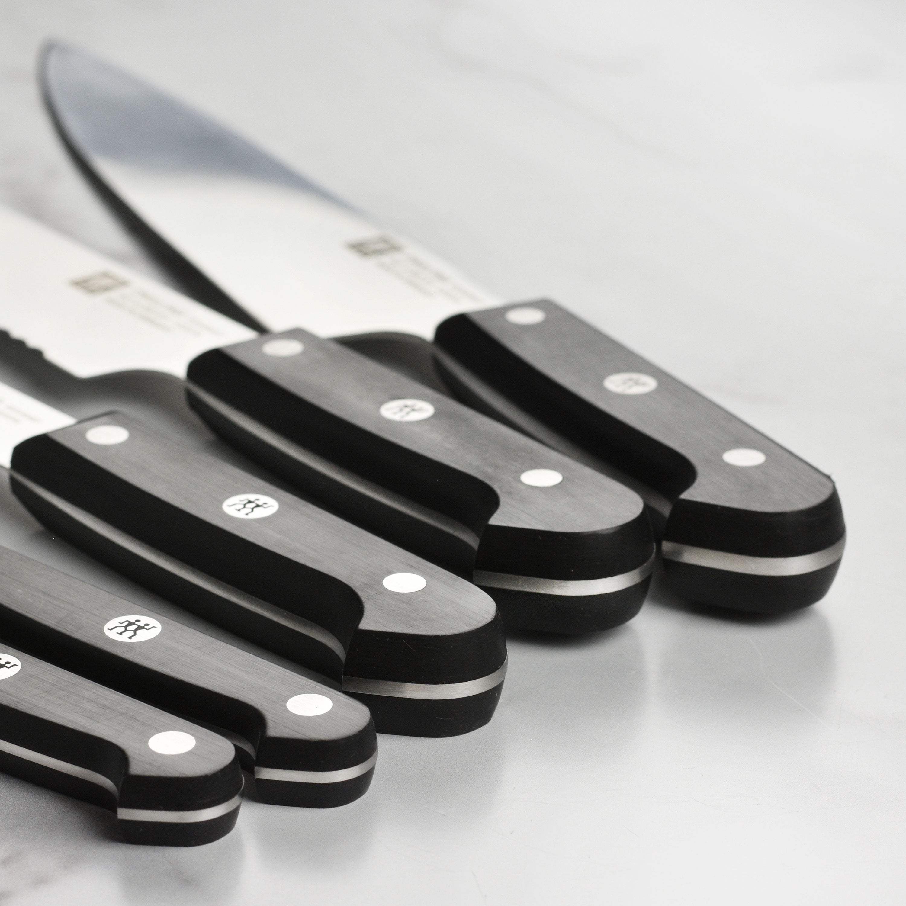 Detailed view of the Zwilling knives, highlighting the precision-honed blades and comfortable handle.