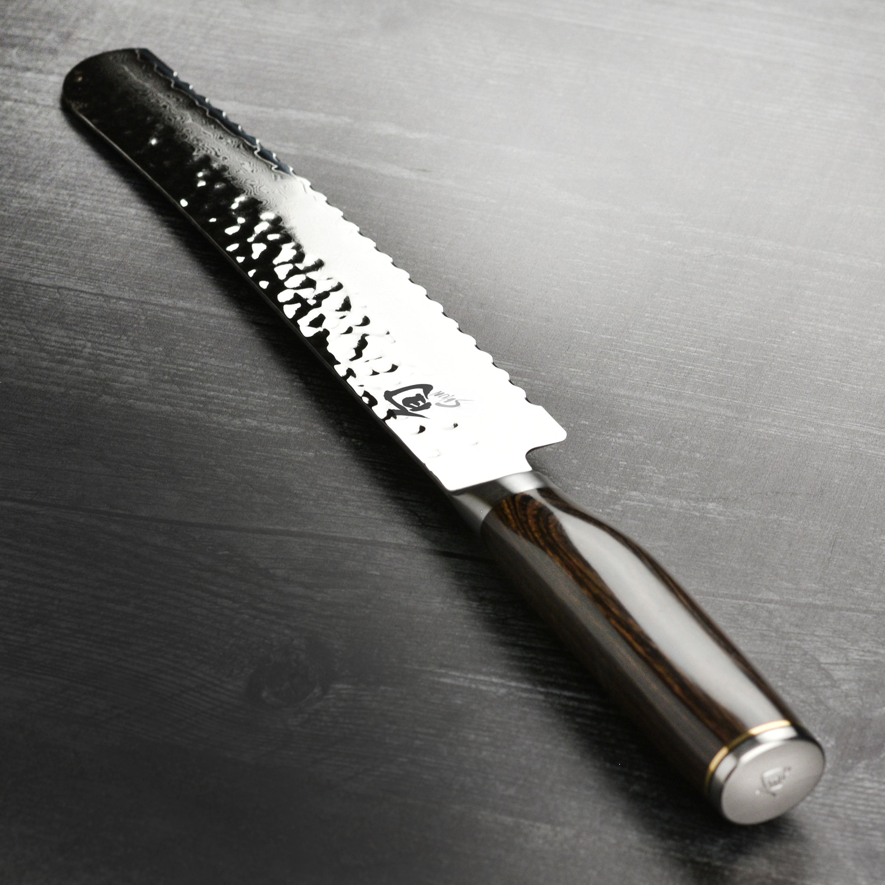 Shun Premier 9-Inch Damascus Bread Knife showcasing the blade and handle design.