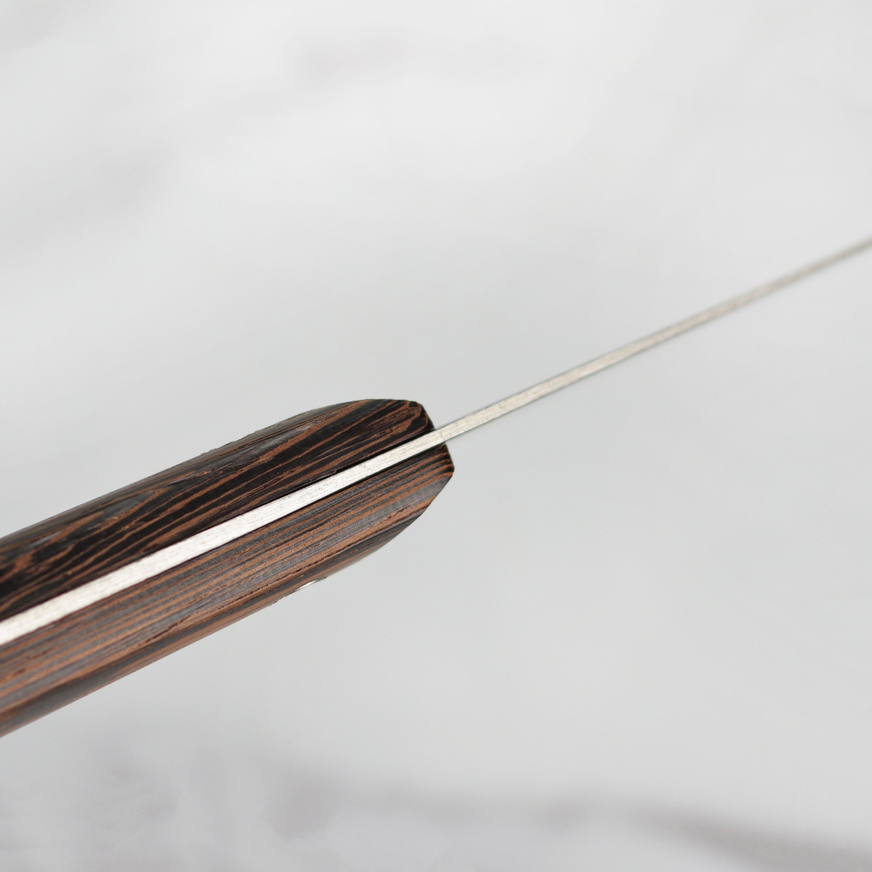 Side view of the Shun Kanso knife set, showcasing the contoured tagayasan wood handle for better grip.
