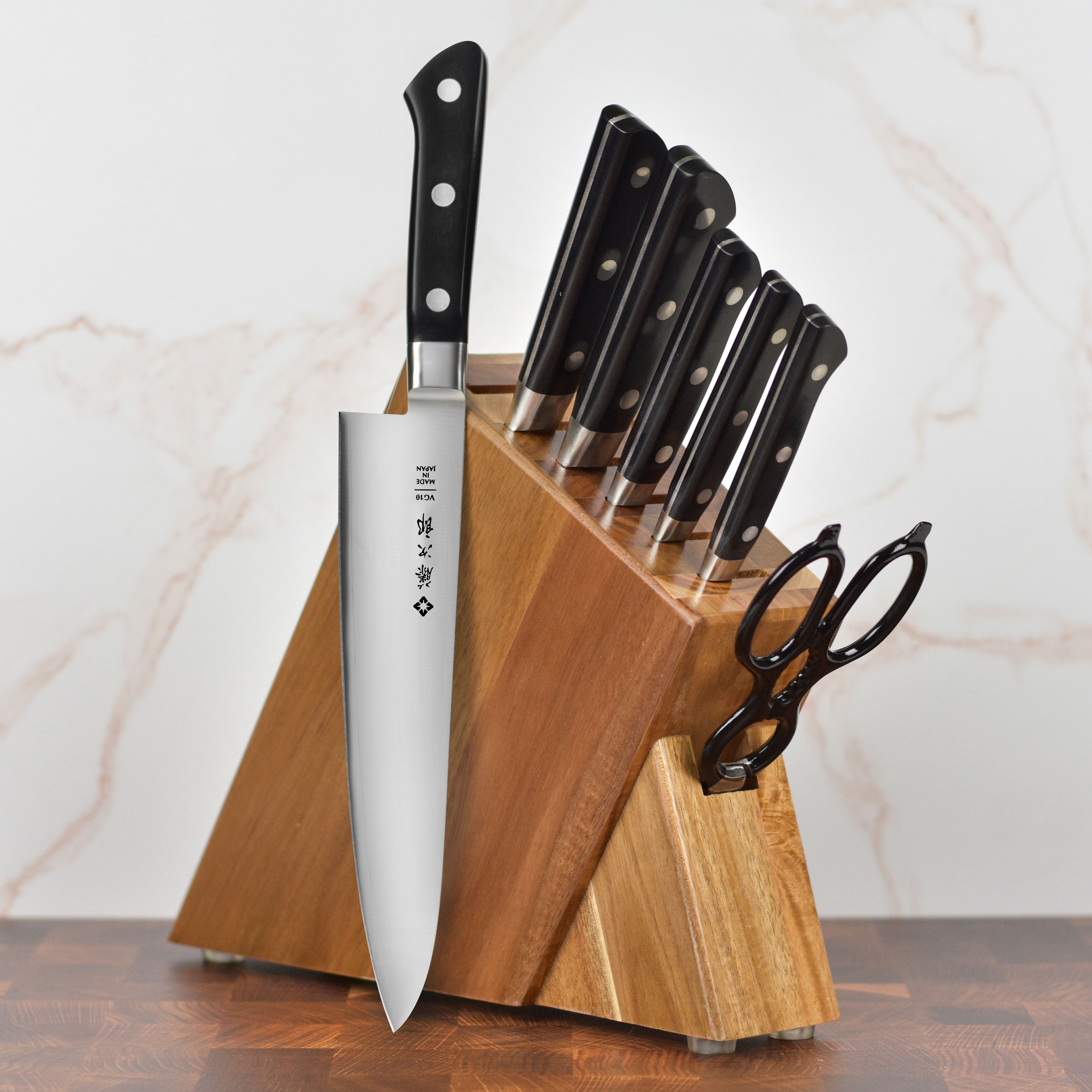 Tojiro Premium Japanese Chef Knife Set displayed on a kitchen counter, showcasing the Acacia block and knives.