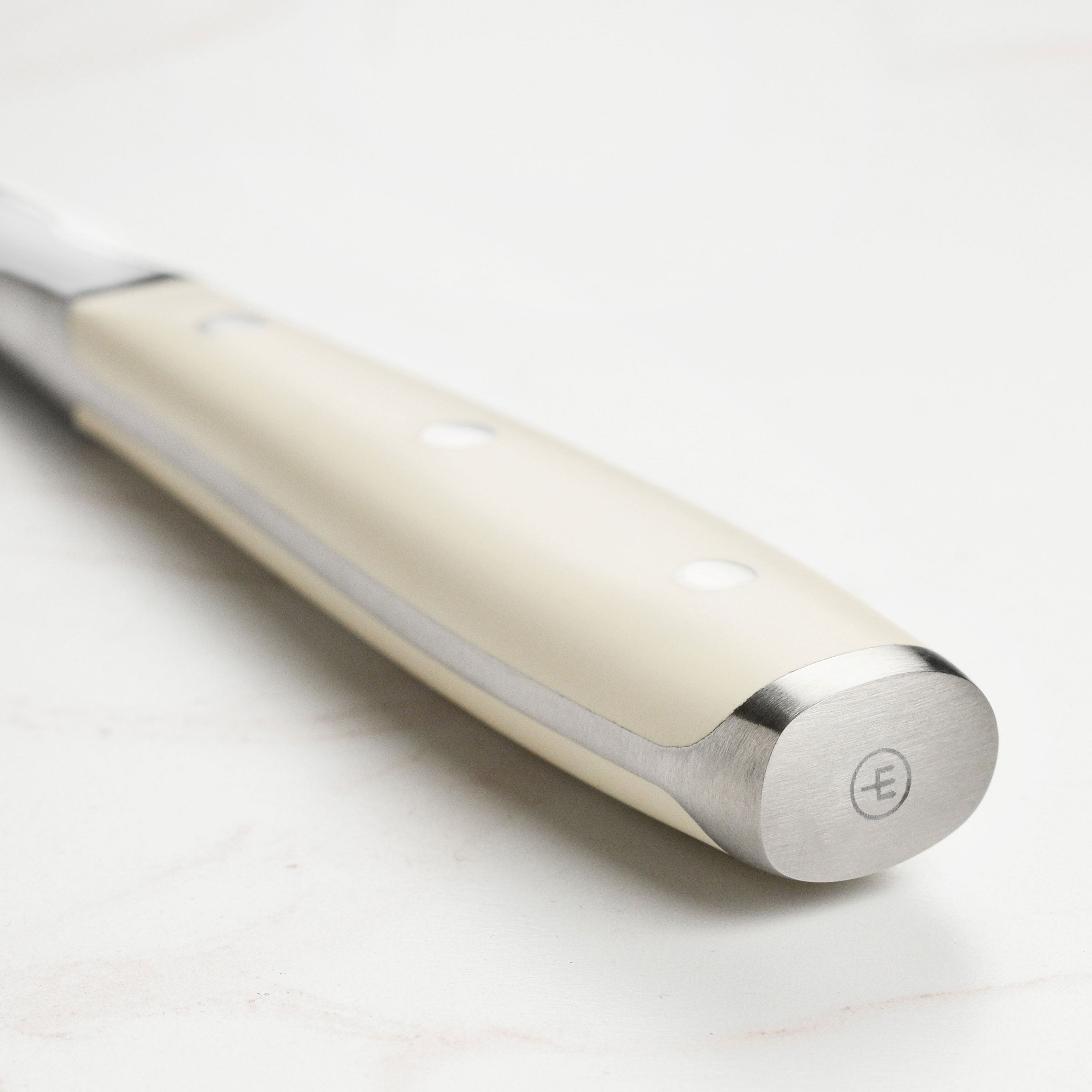 Close-up of the carving fork’s two stainless-steel prongs holding meat firmly