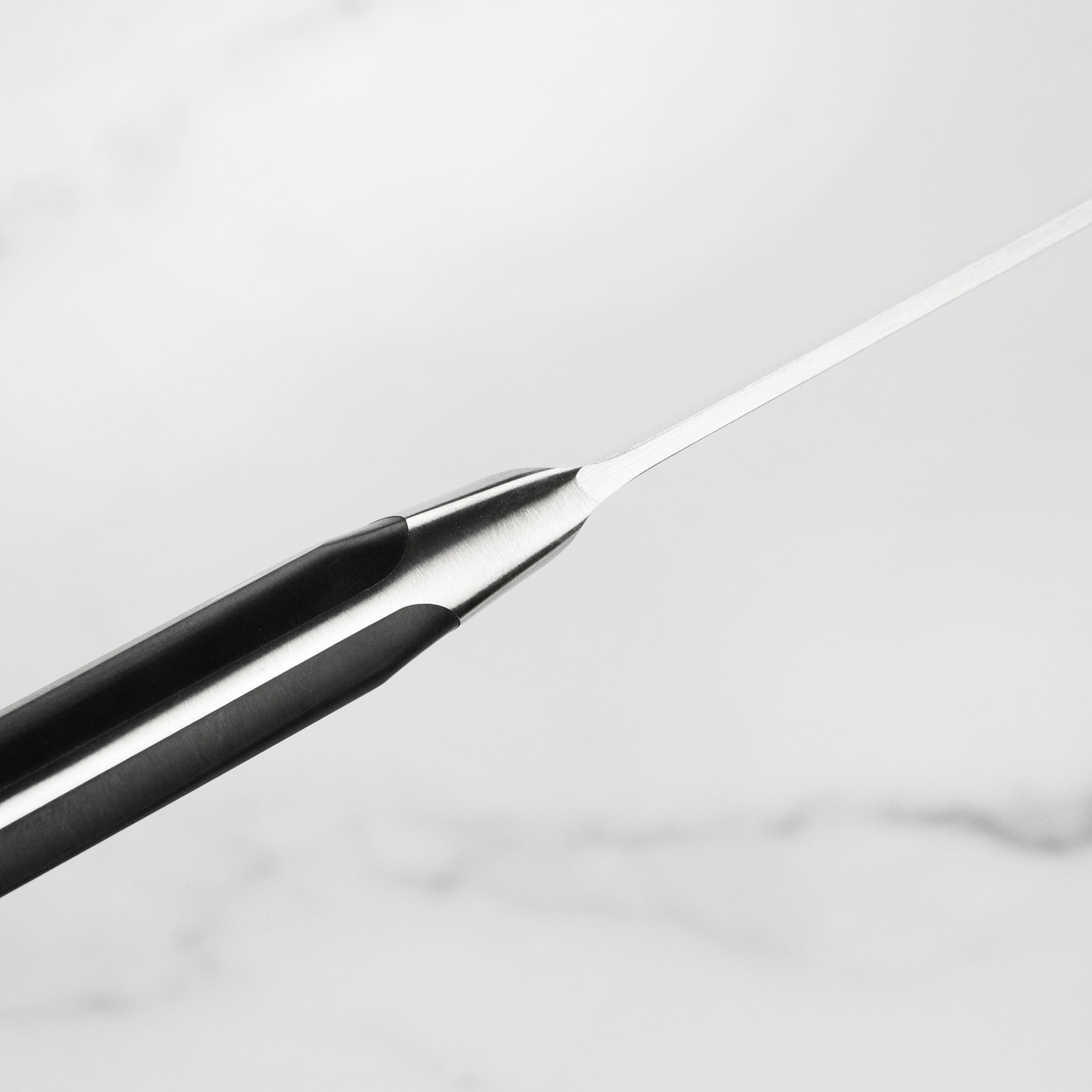 Detailed view of the handle and blade of a Wusthof kitchen knife for professional chefs