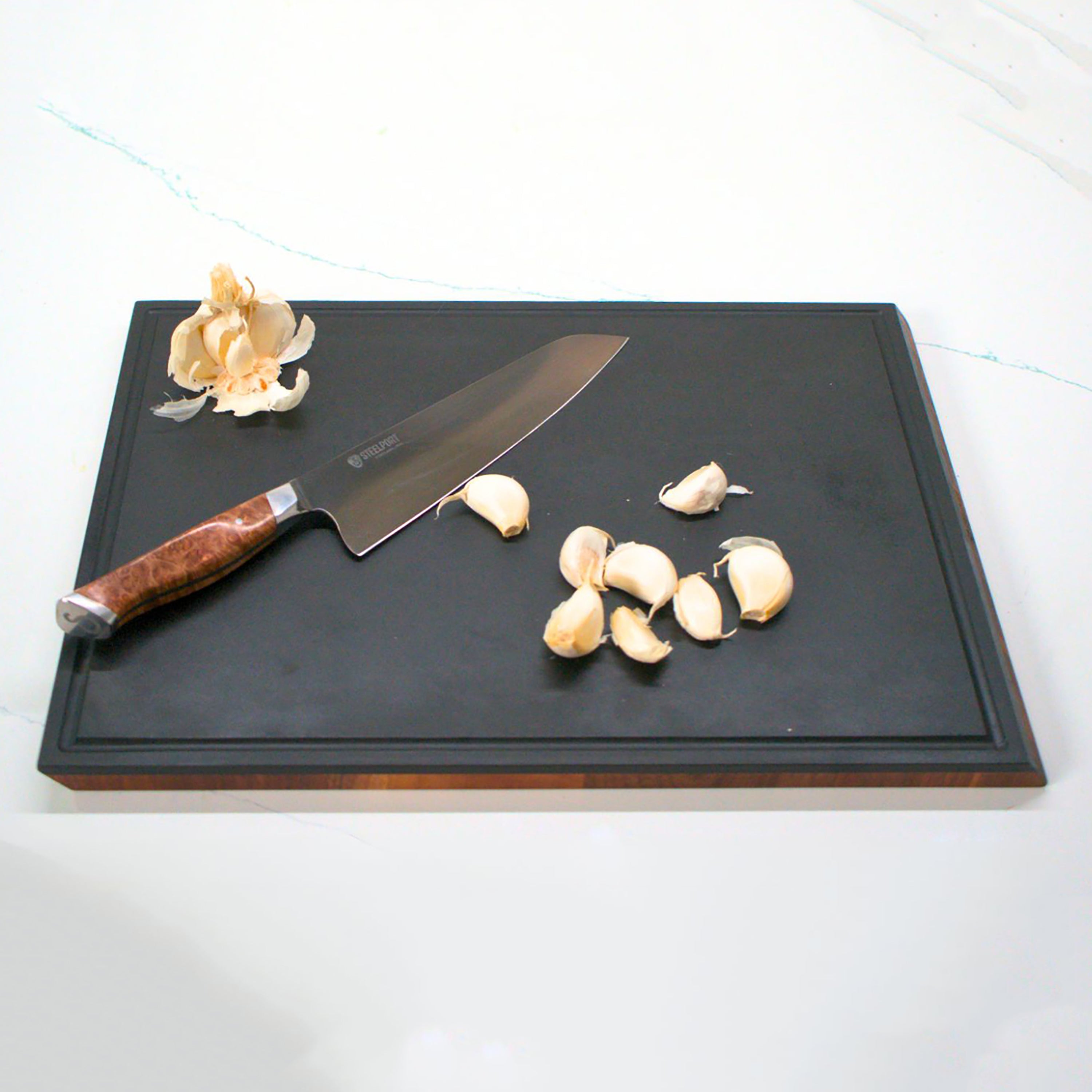 Side view of Steelport end-grain walnut cutting board highlighting beveled edges and slim profile