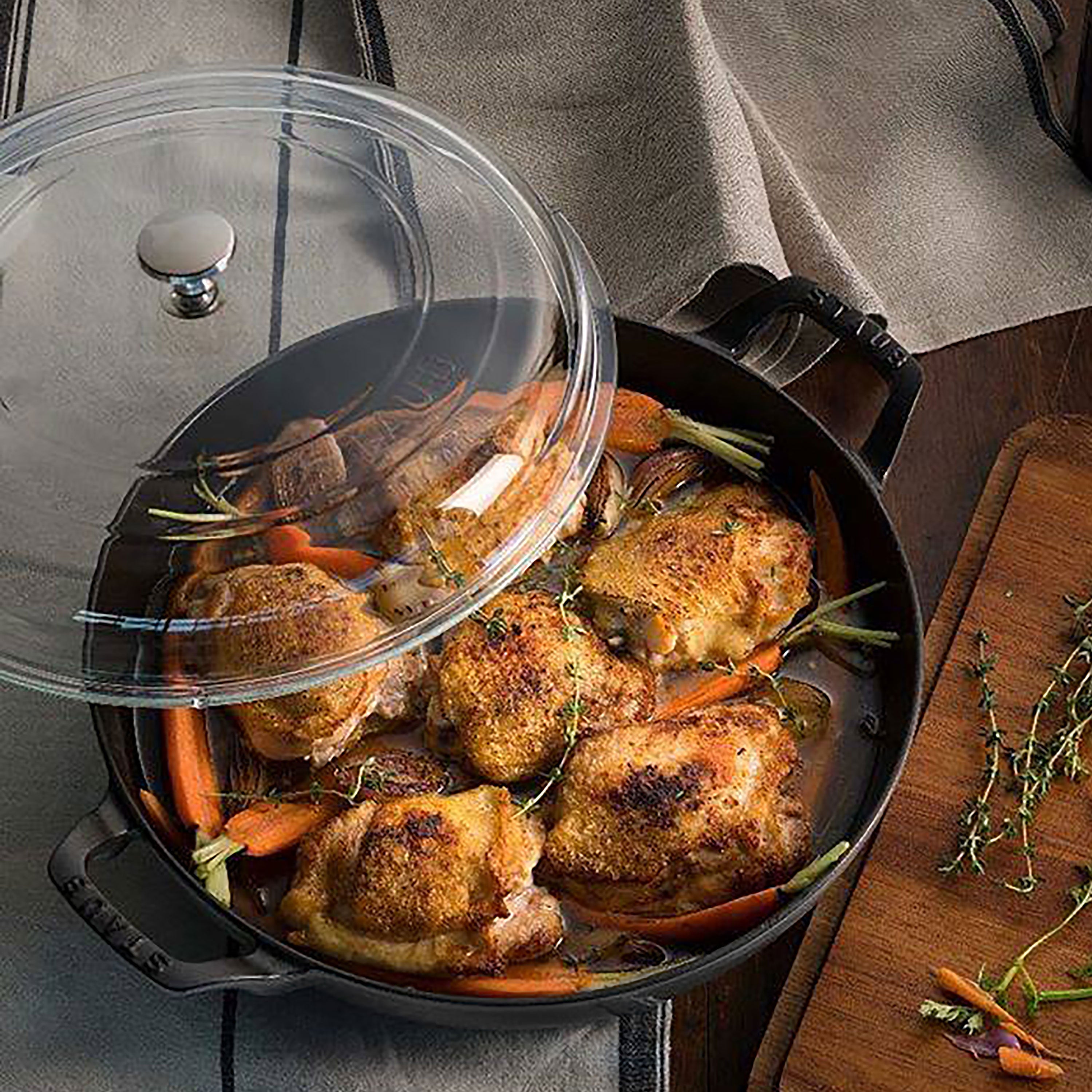 Staub enameled cookware in use, simmering a hearty stew on the stove.