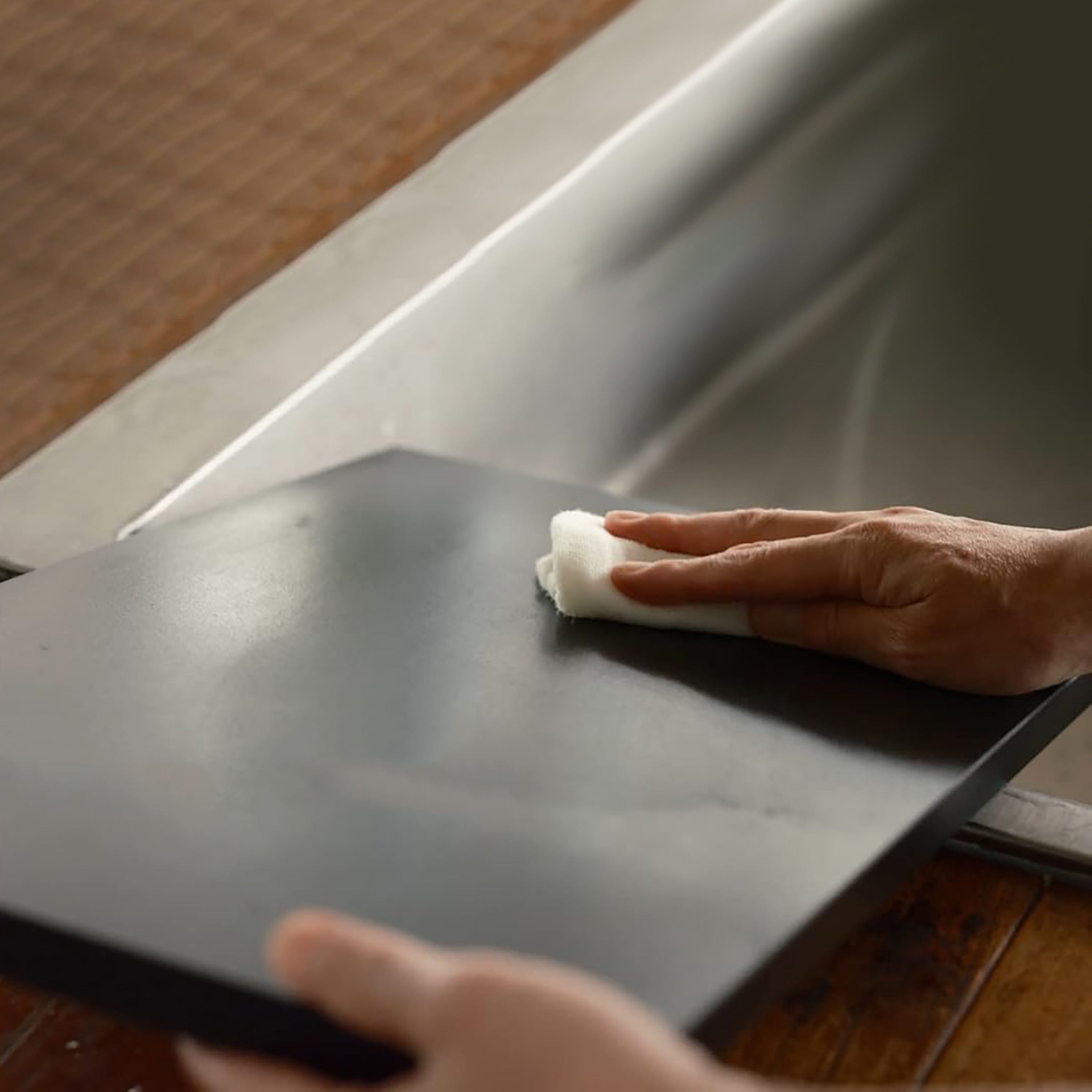 Asahi Elite Anti-Slip Rubber Cutting Board viewed from above, highlighting its matte black finish and large surface area.