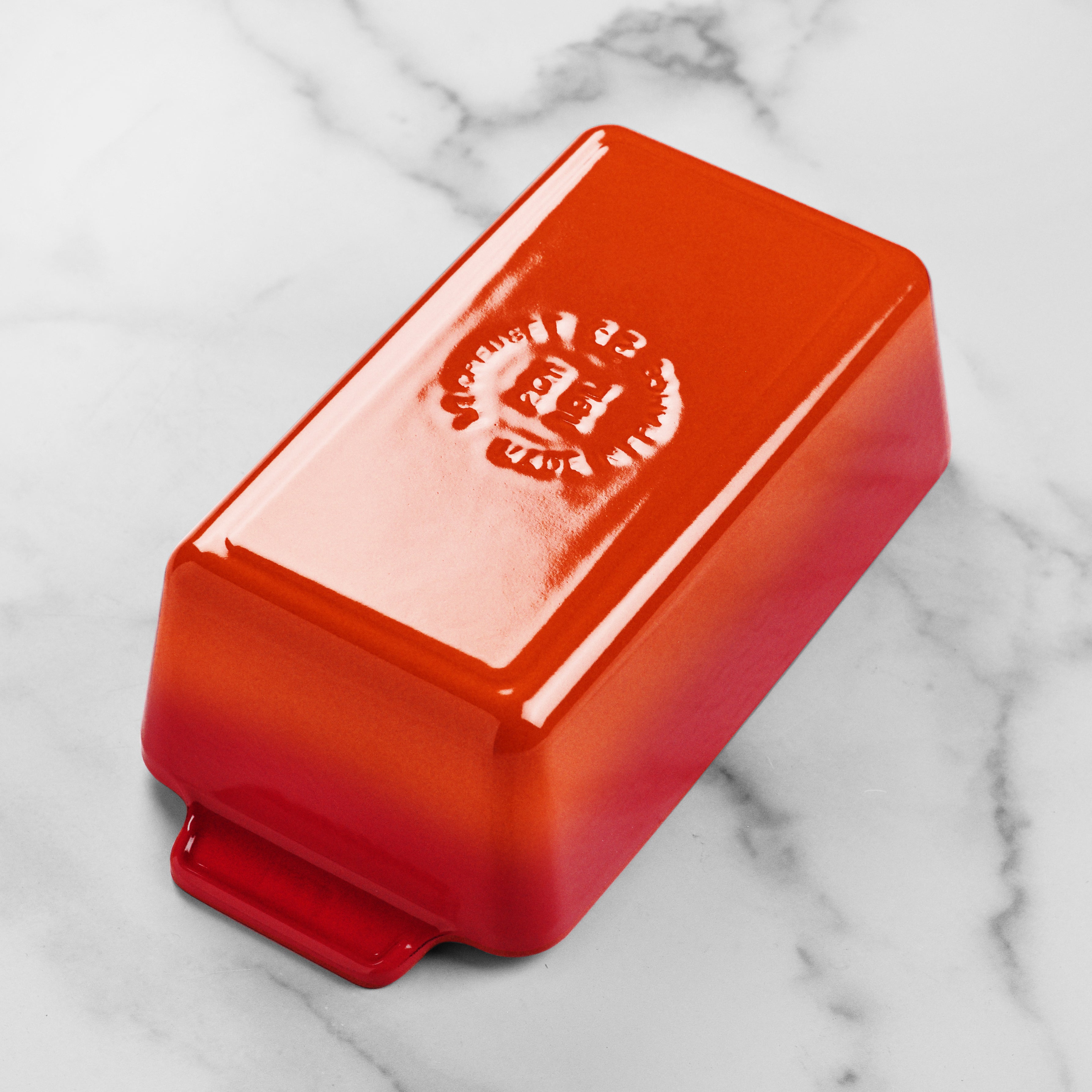 Le Creuset cast iron loaf pan showcasing its vibrant flame color and durable enamel finish.