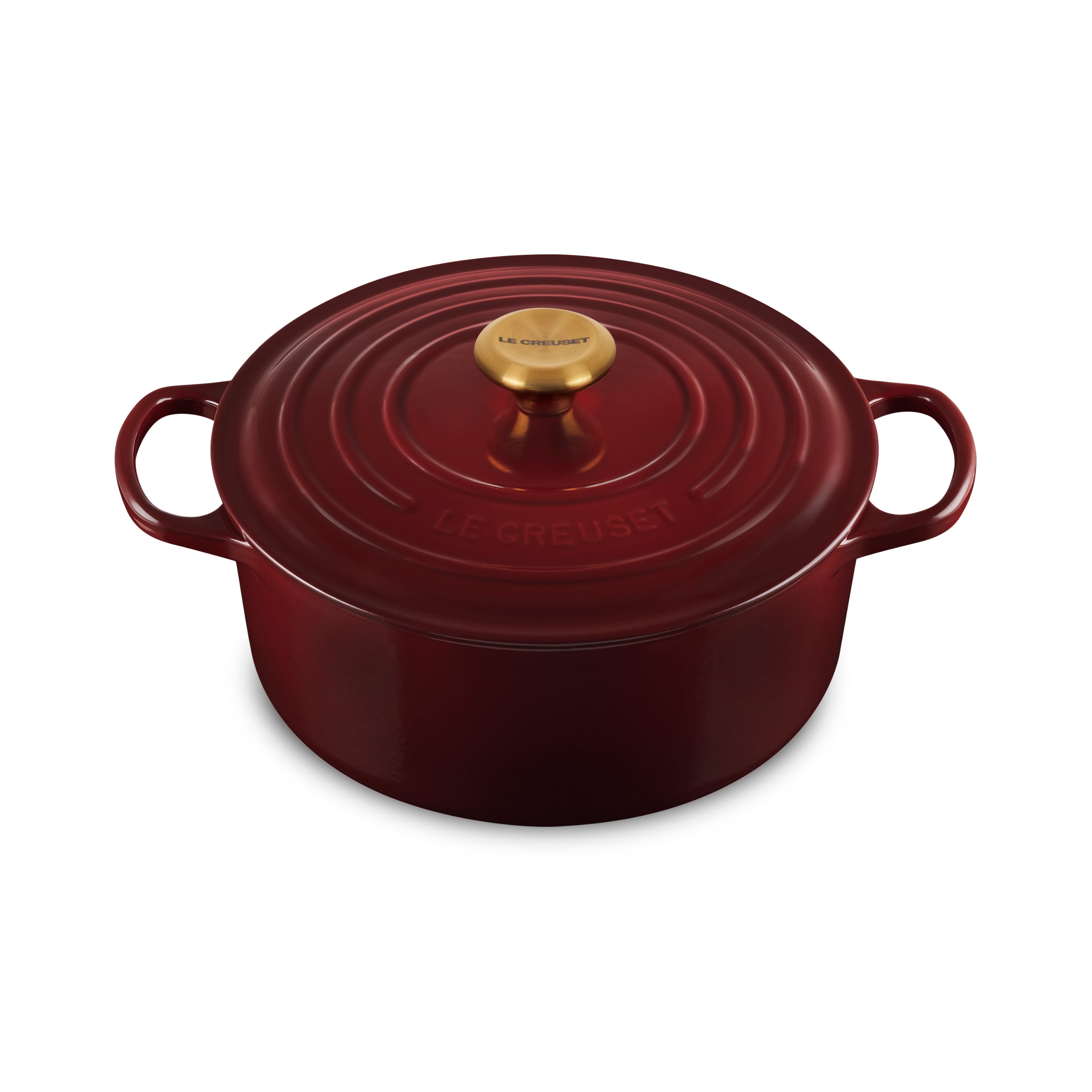 Top-down view of the Le Creuset Rhone Dutch oven on an induction stovetop, highlighting its gold knob and premium finish.