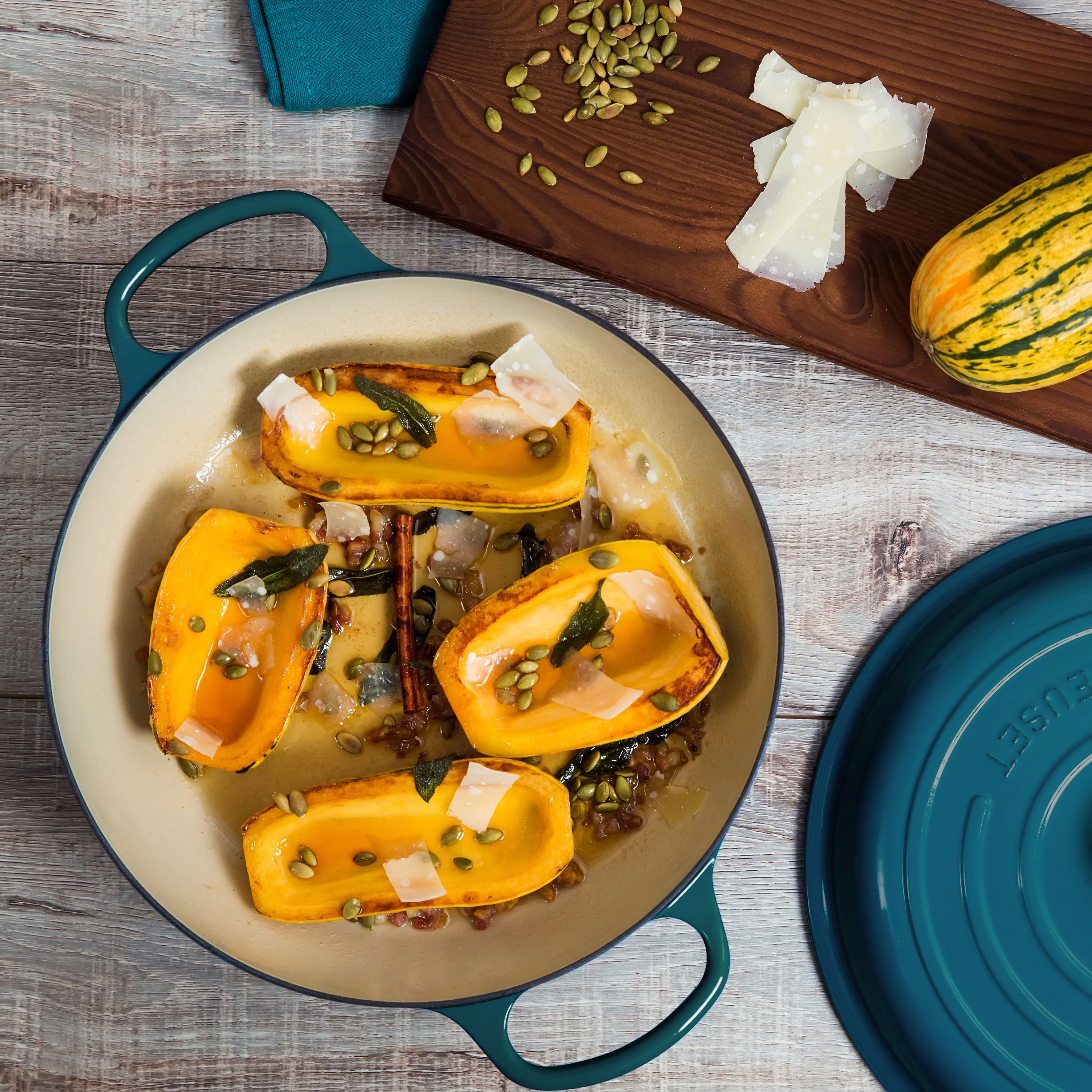 Top view of Le Creuset Deep Teal cast iron cookware set arranged on an induction cooktop