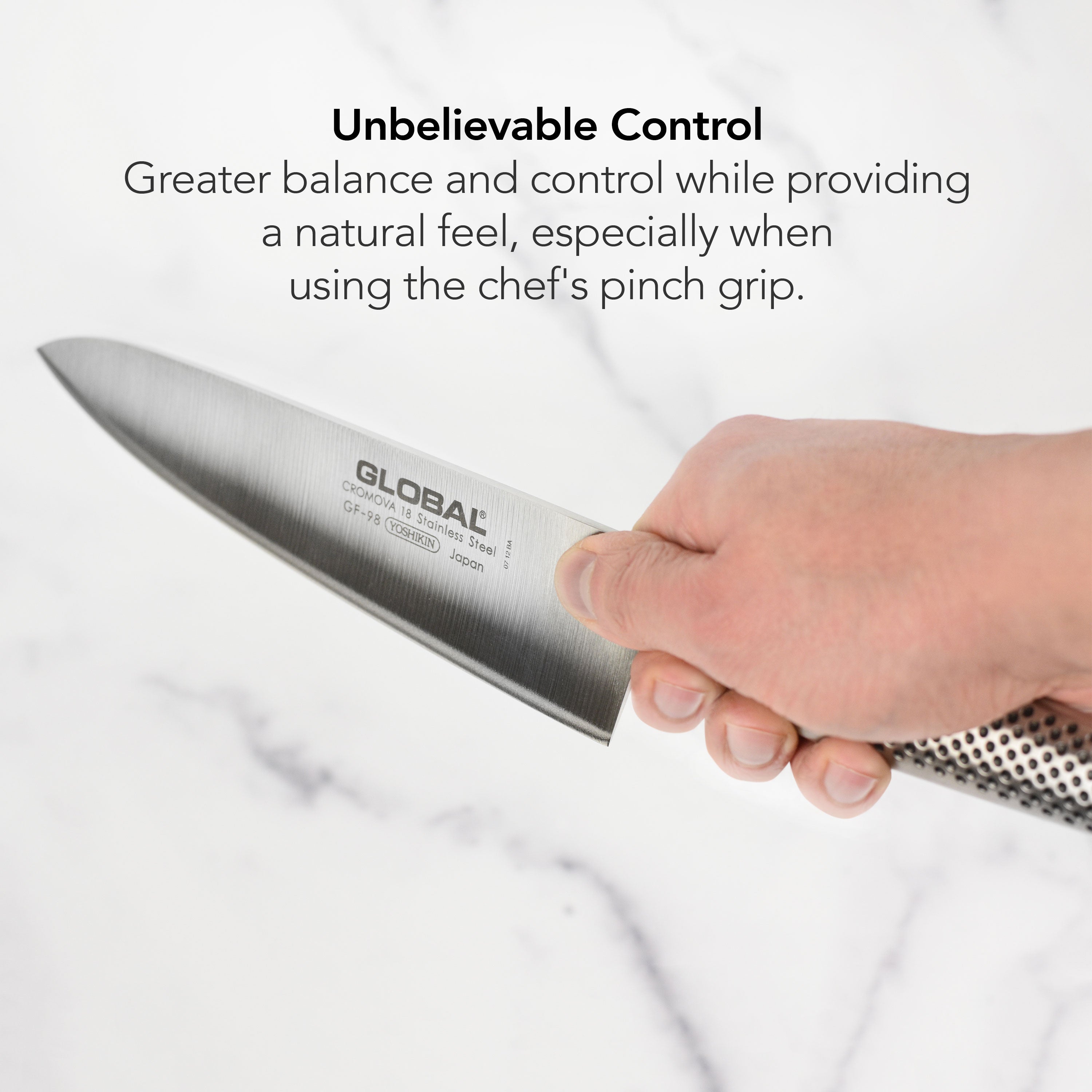 Set of Japanese kitchen knives including a chef knife and paring knife on a wooden cutting board