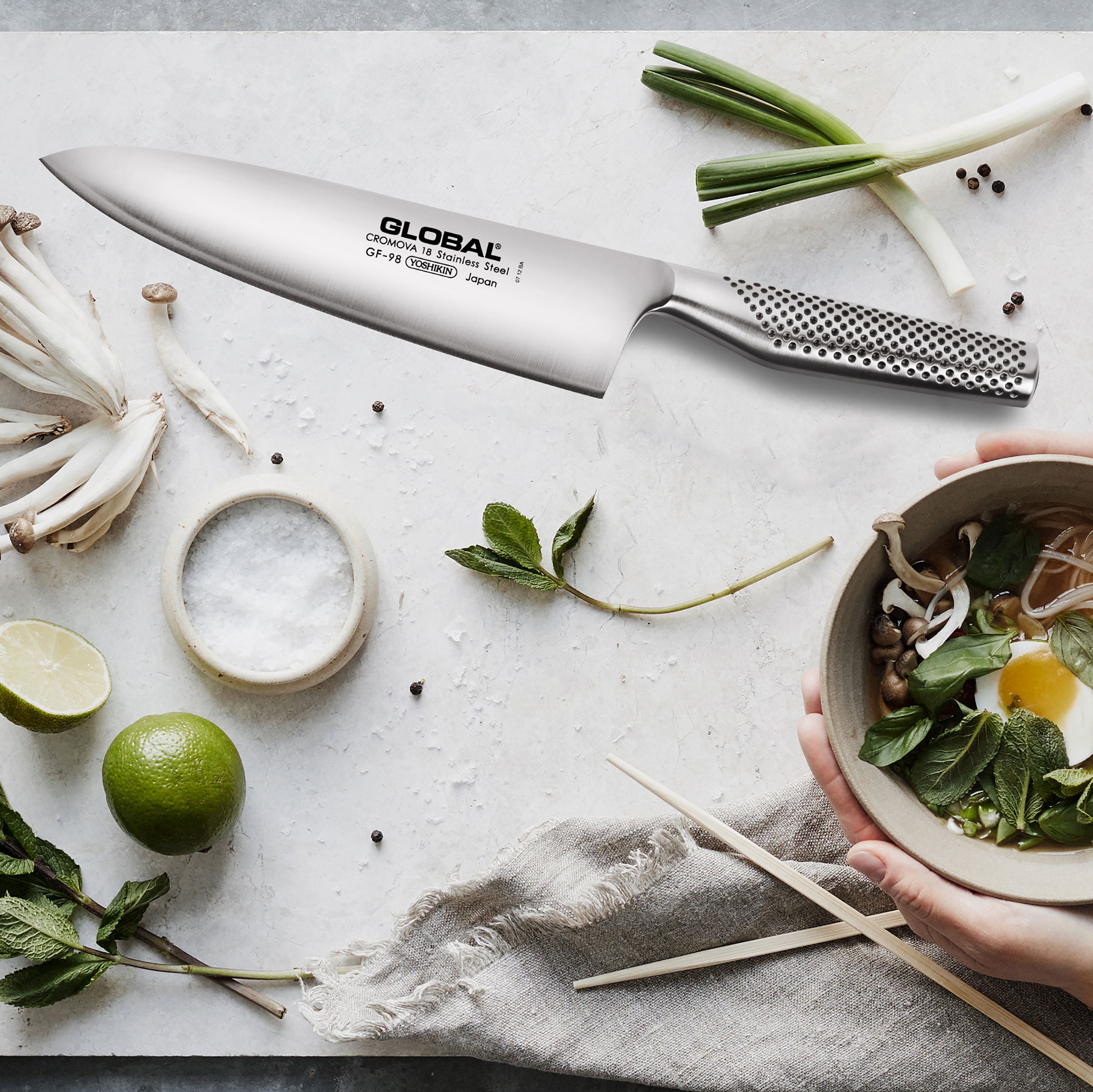 Close-up of a high carbon stainless steel chef knife with ergonomic handle for professional cooking