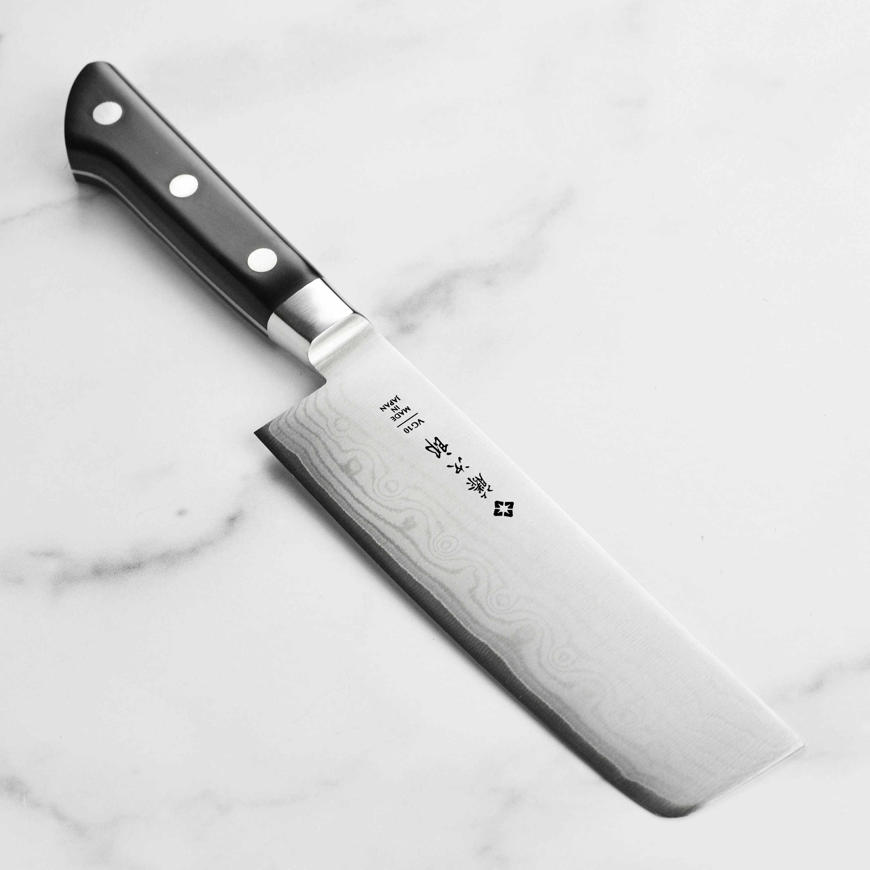 Close-up of the layered damascus pattern on Tojiro Nakiri Knife blade