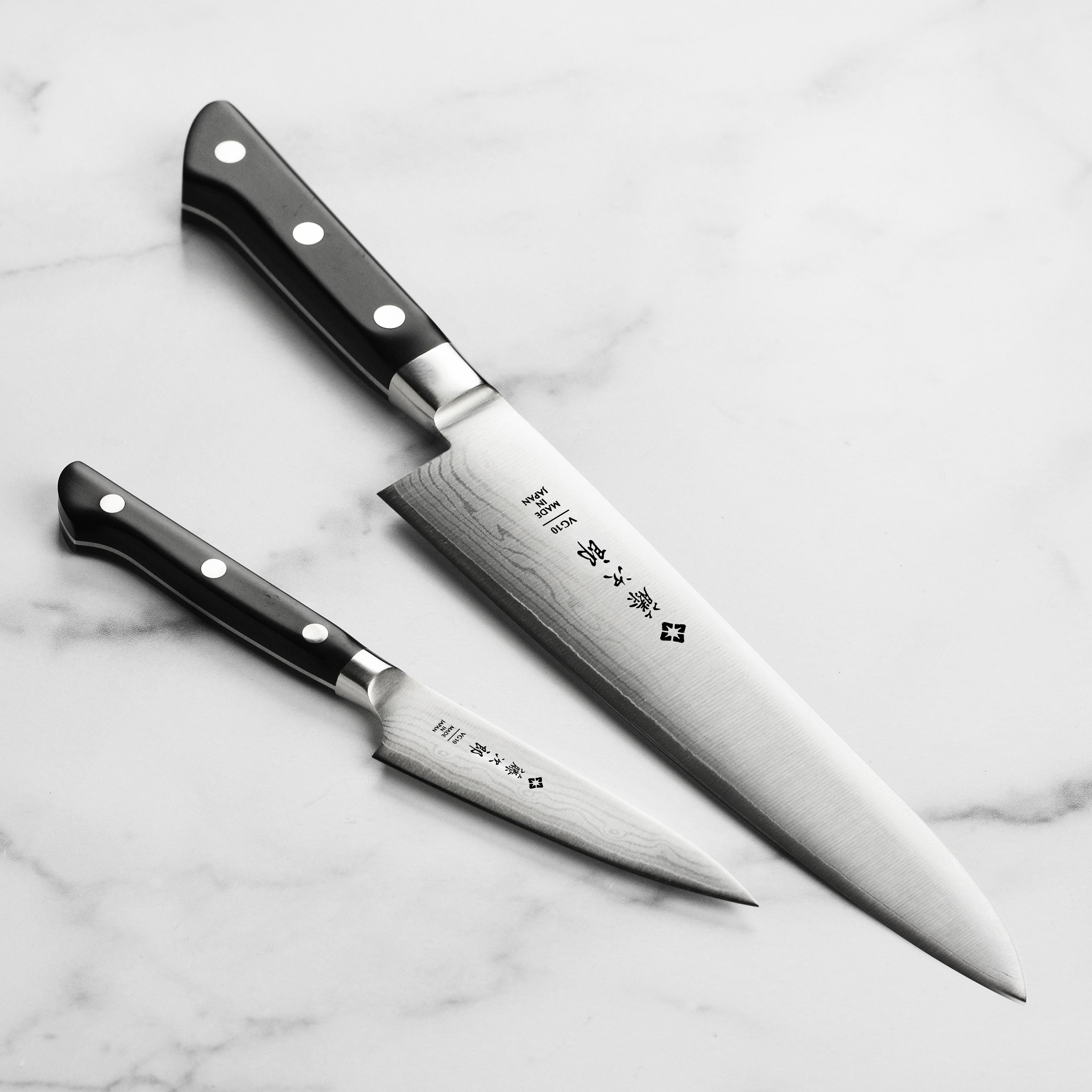 Close-up of the Damascus pattern on the chef's blade showcasing layered steel