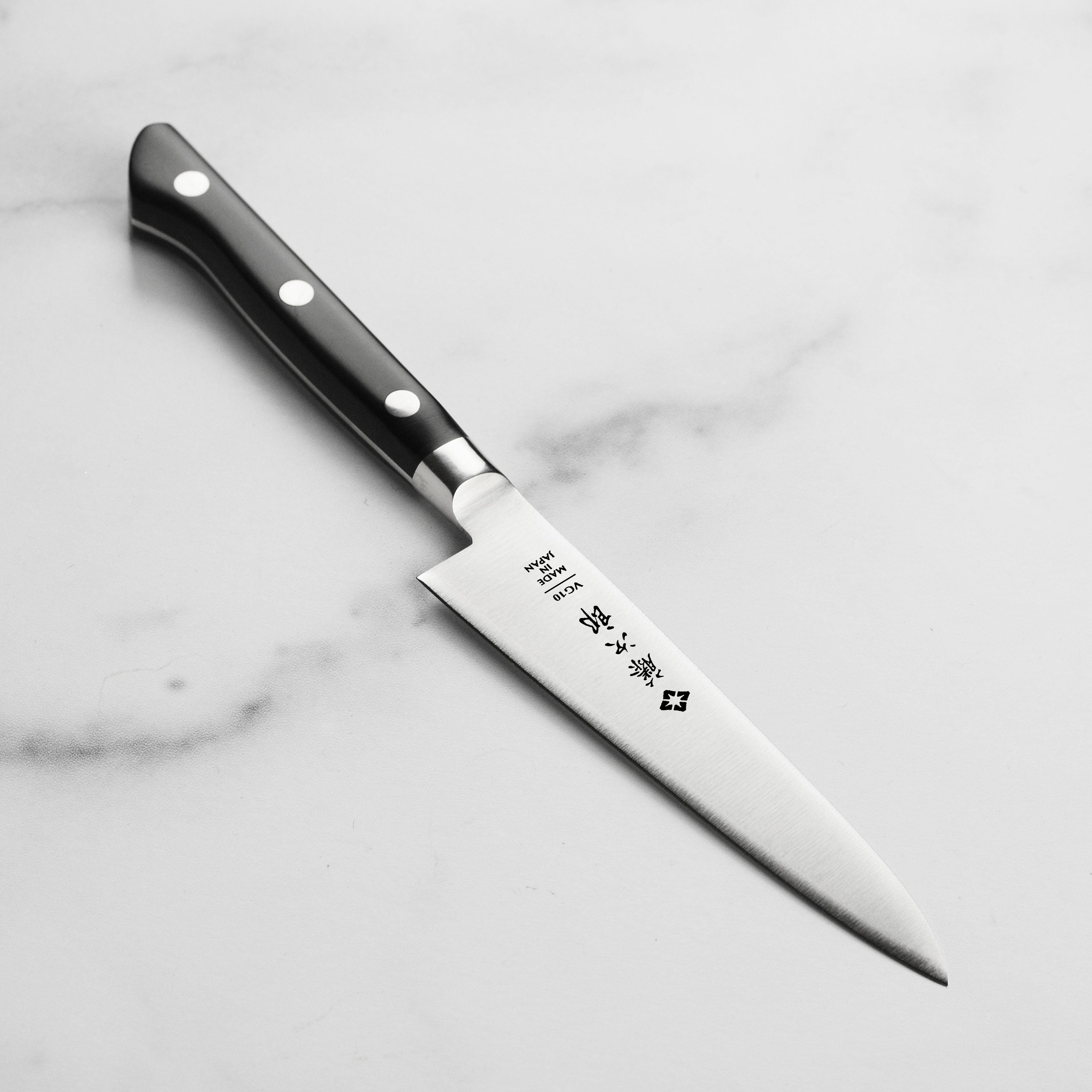 Side profile of Tojiro Elite 4.5 inch Japanese knife showing full tang and micarta handle