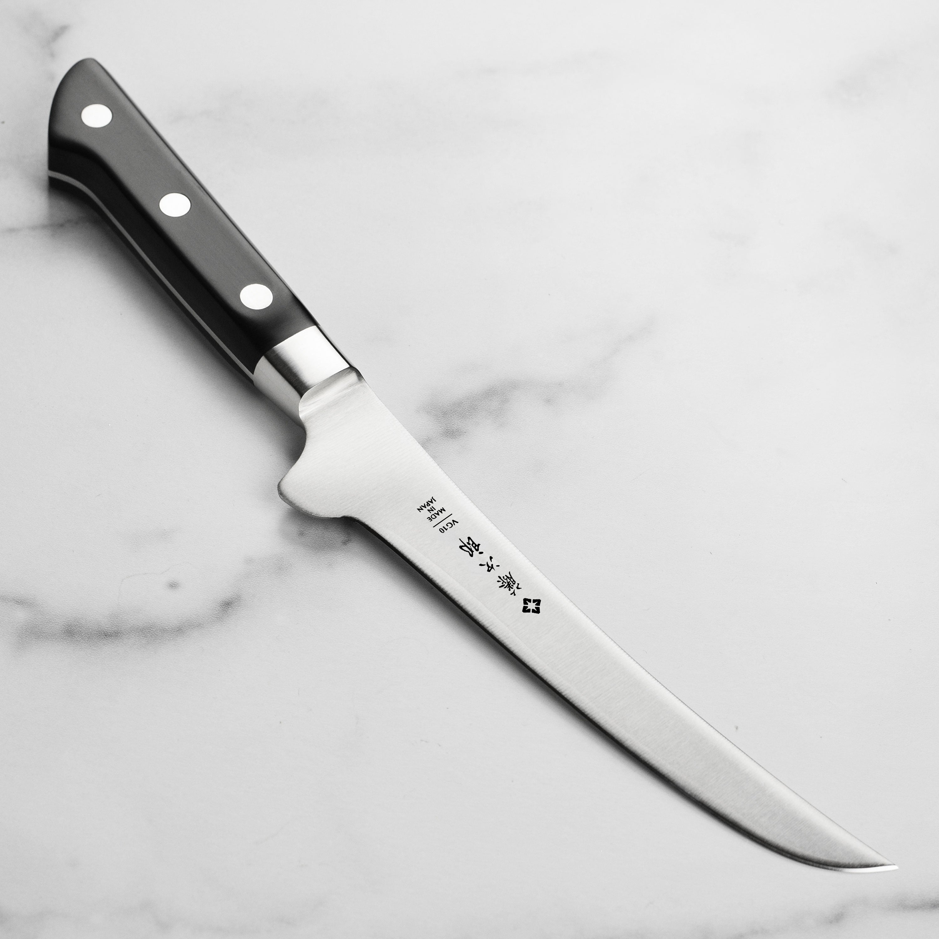 Tojiro curved boning knife with VG10 steel blade and micarta handle for professional meat preparation