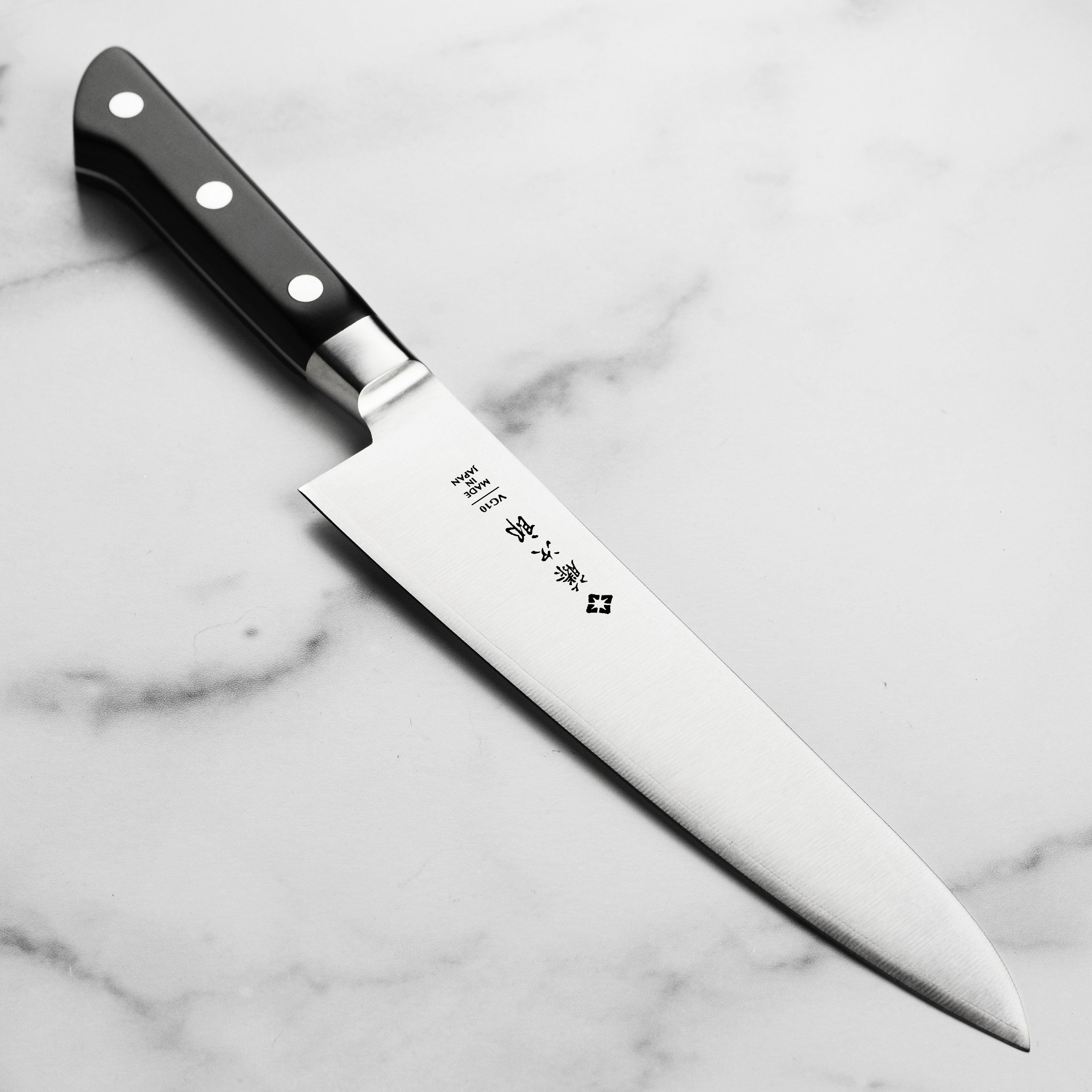 Front view of the Tojiro Classic Japanese chef's knife highlighting its sharp blade and ergonomic handle