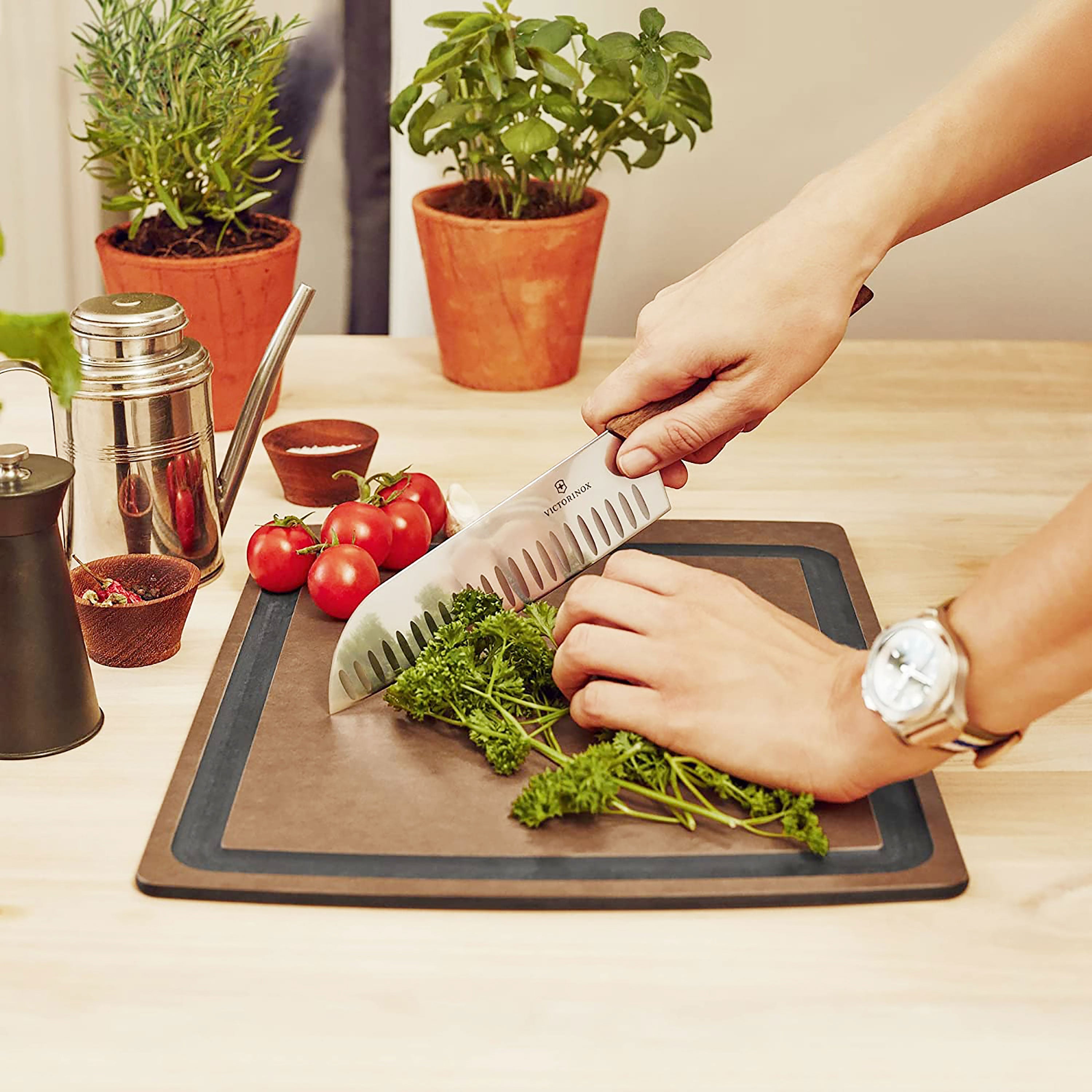 Victorinox Swiss Modern Santoku knife in a kitchen setting, demonstrating its perfect balance and ergonomic grip.